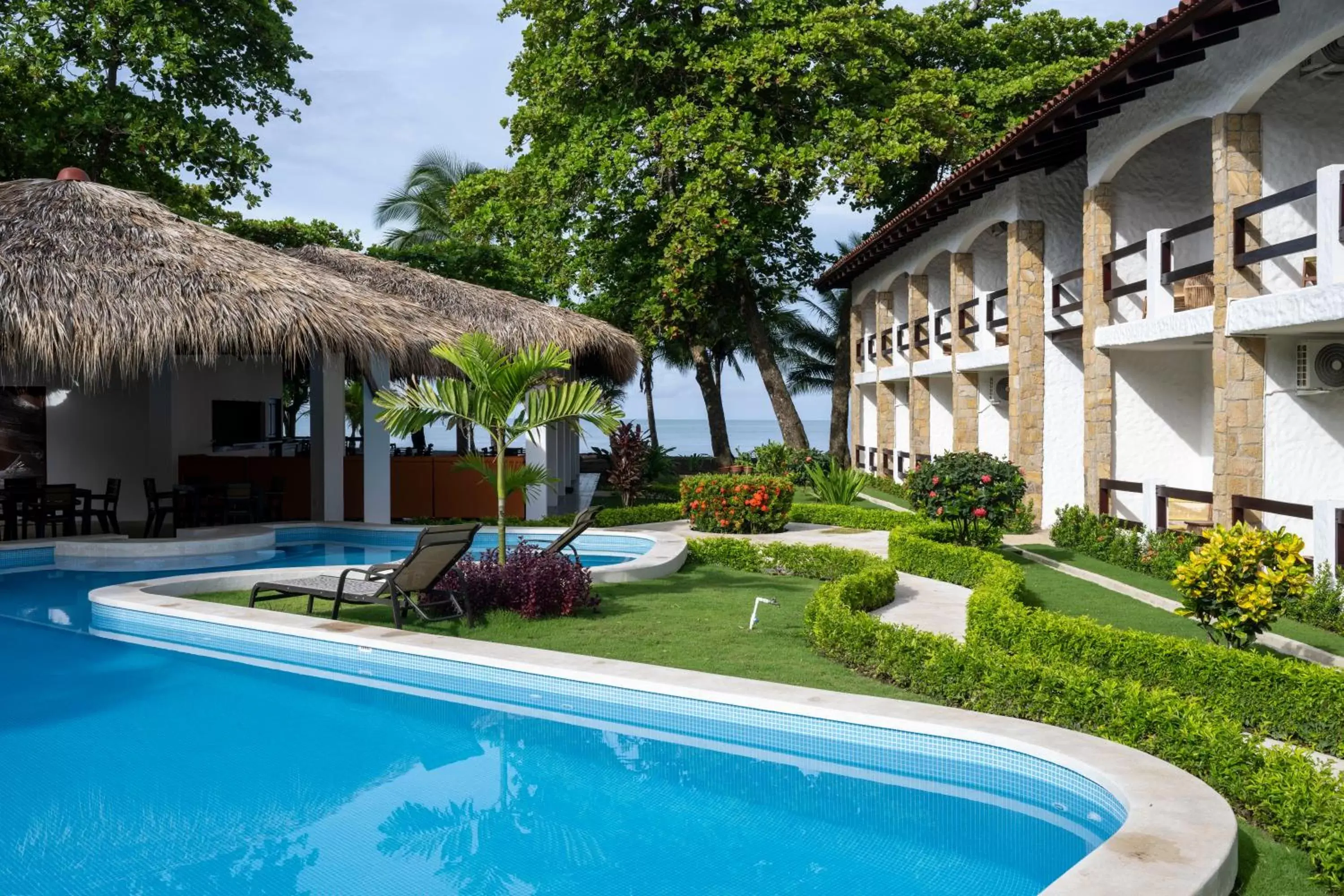 Swimming pool, Property Building in Fuego del Sol Beachfront Hotel