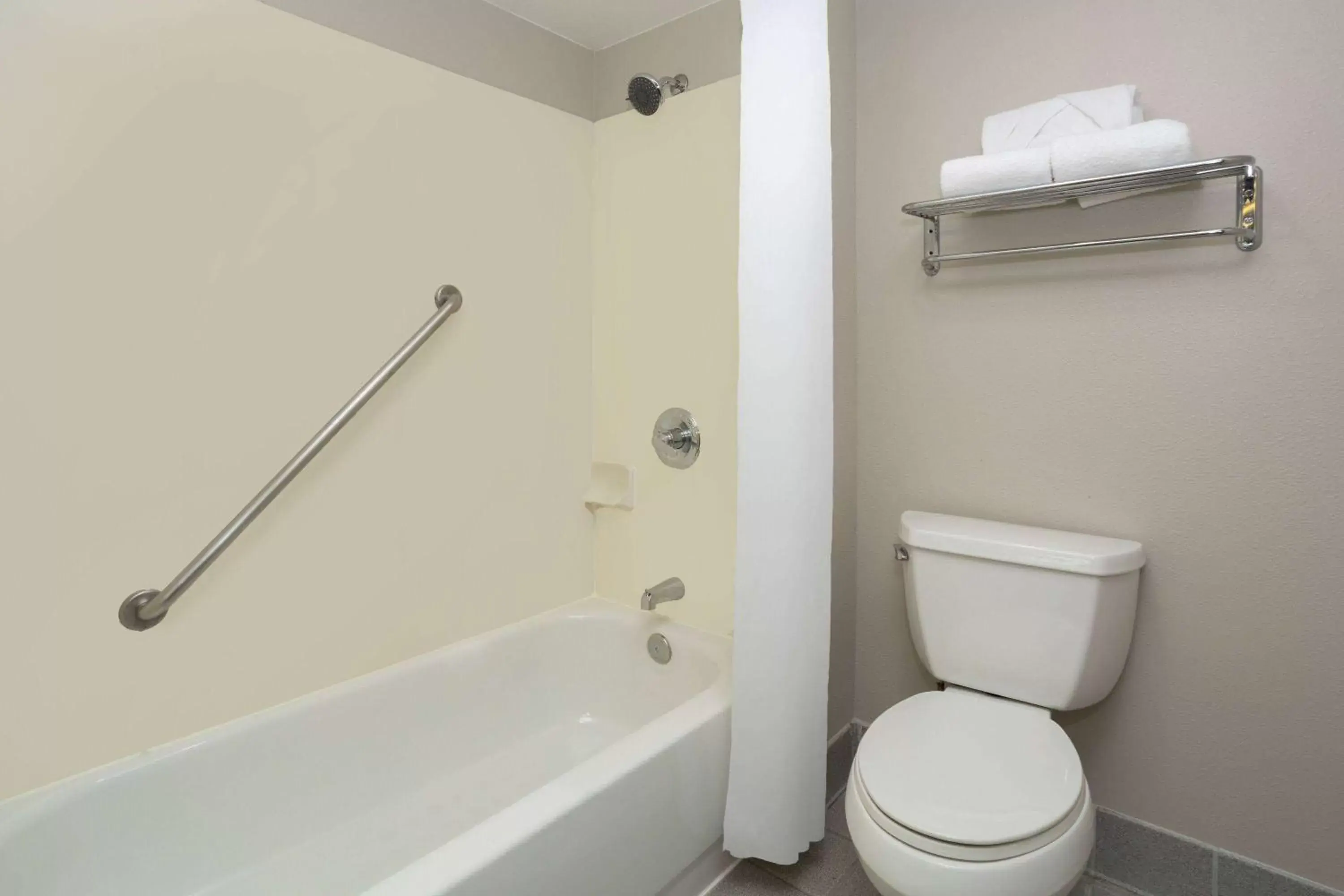 TV and multimedia, Bathroom in Days Inn & Suites by Wyndham Denver International Airport