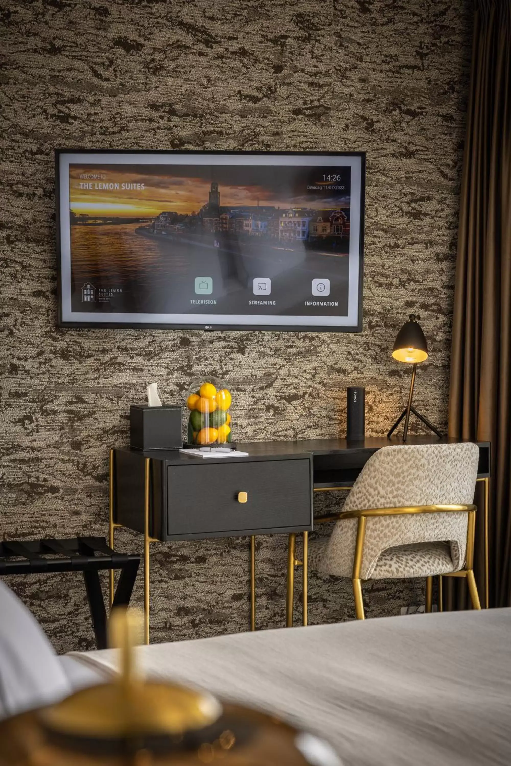 Bed, TV/Entertainment Center in The Lemon Suites