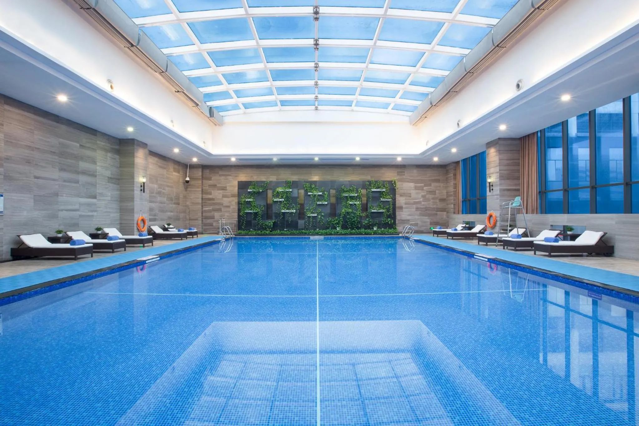 Swimming pool in Crowne Plaza Shenzhen Longgang City Centre by IHG