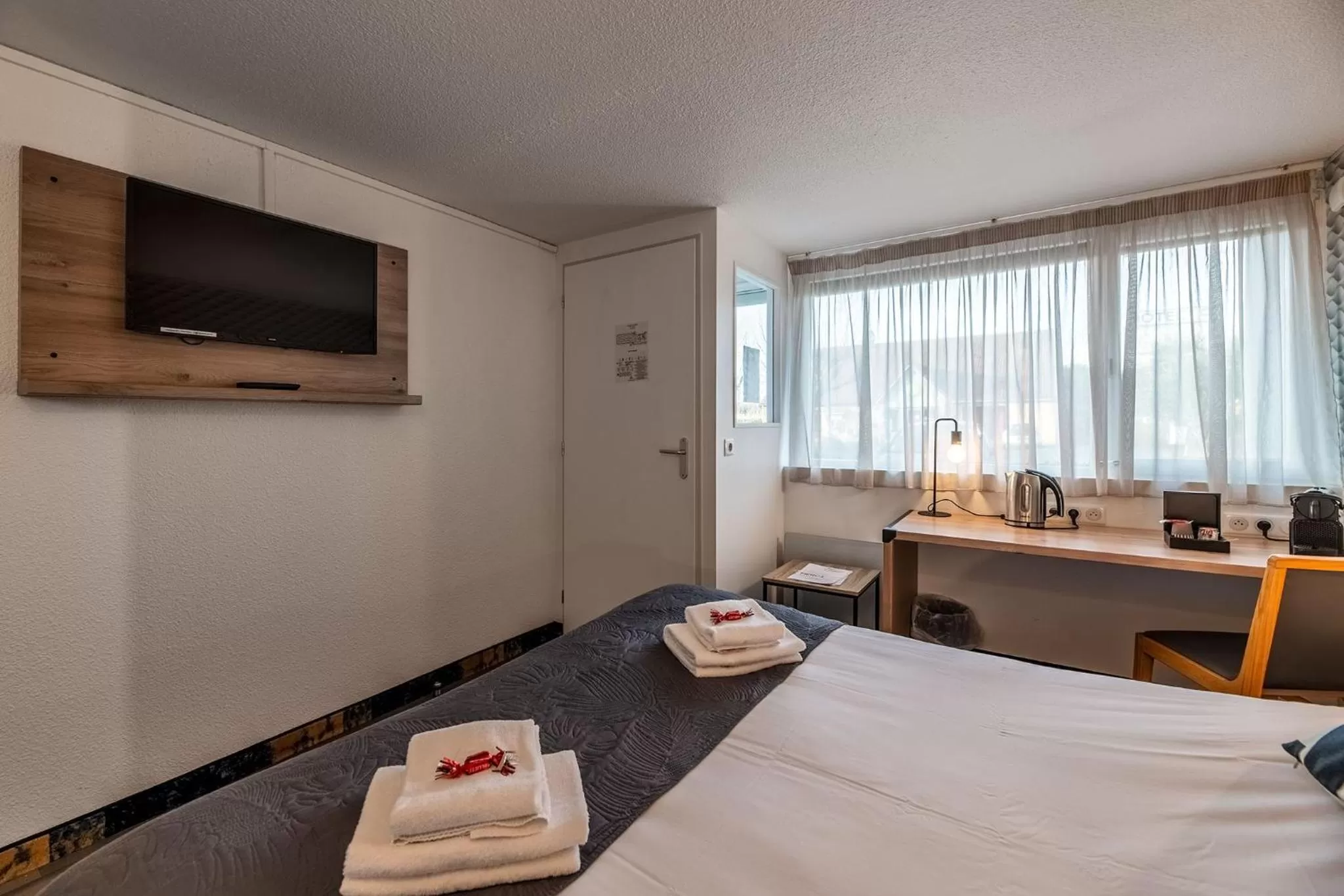 Photo of the whole room, Bed in Hôtel Le Cyrano Bergerac