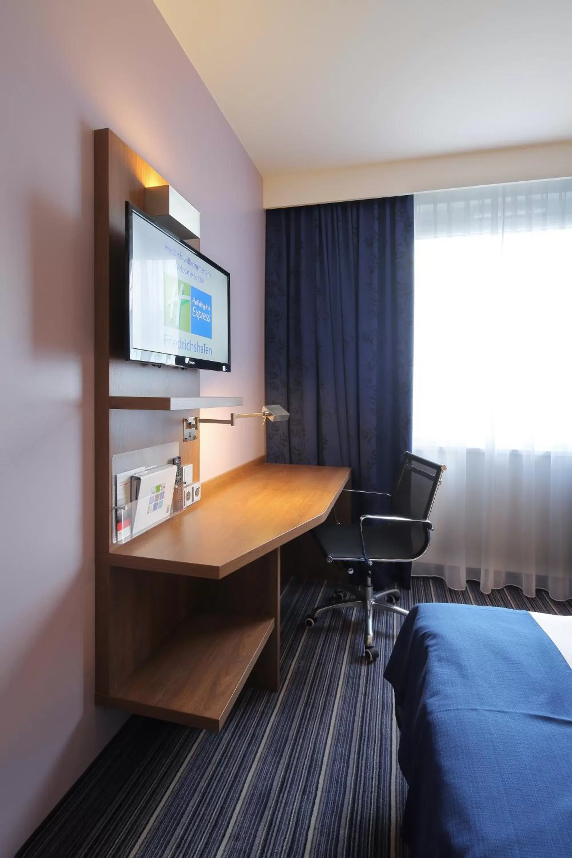 Photo of the whole room, TV/Entertainment Center in Holiday Inn Express Friedrichshafen, an IHG Hotel