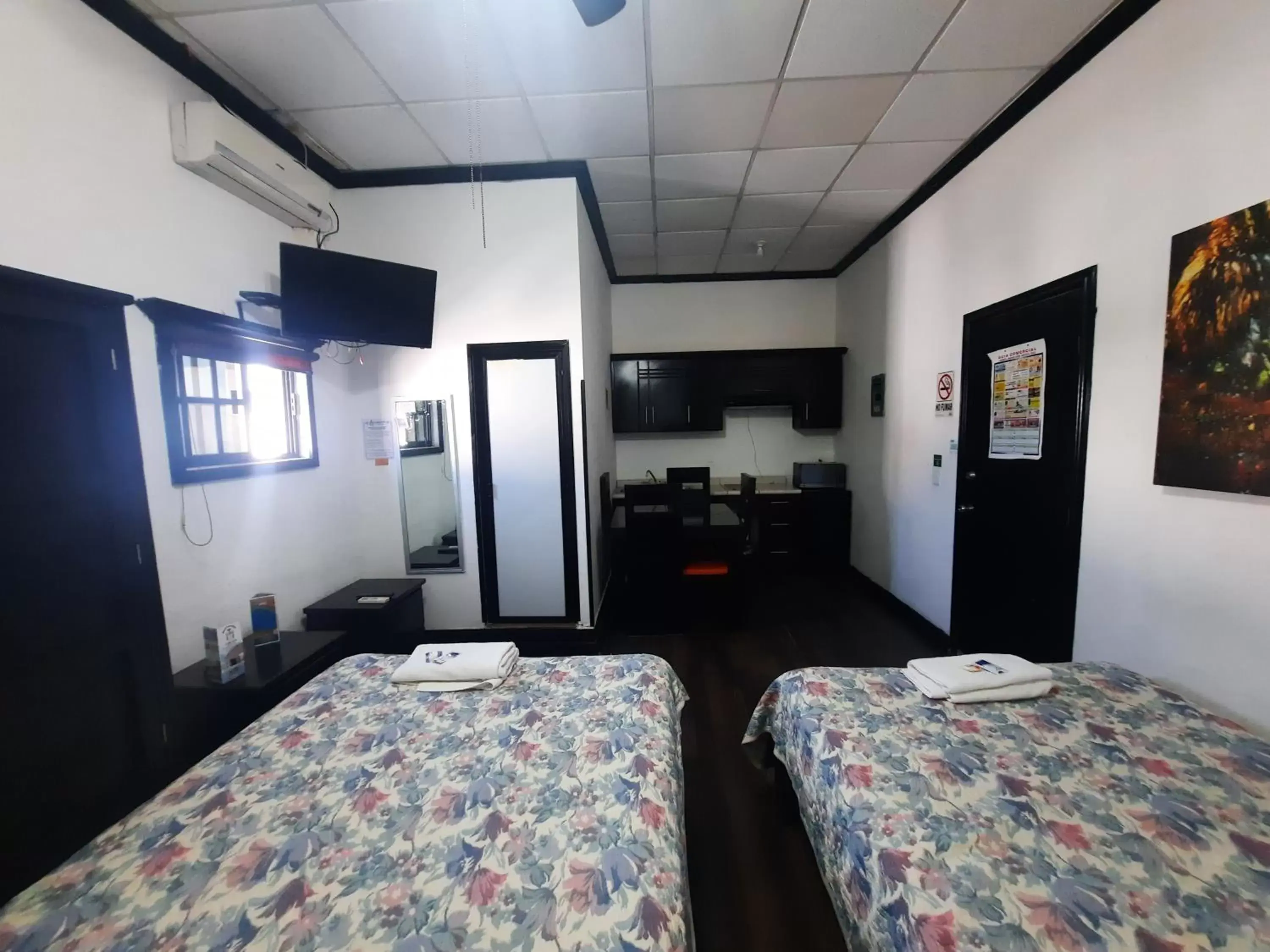 Bed in Garcias Suites y Hotel