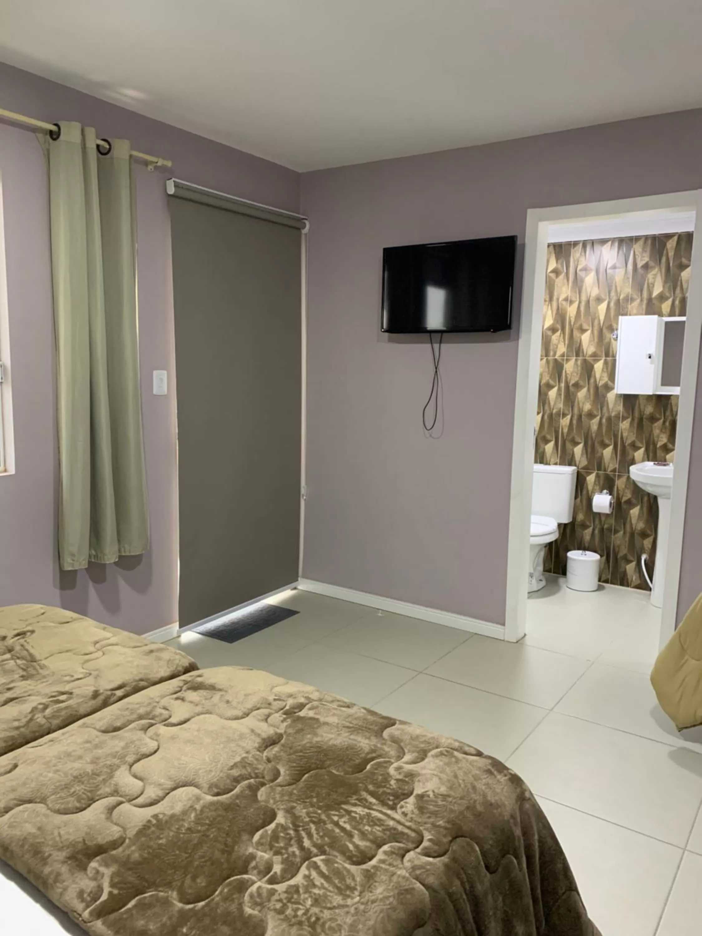 Bed in Pousada Mercosul