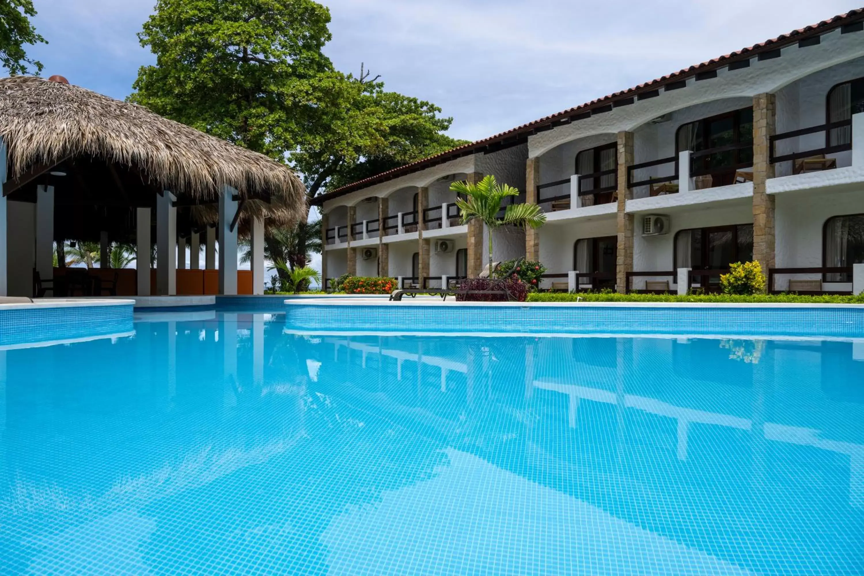 Swimming pool, Property Building in Fuego del Sol Beachfront Hotel