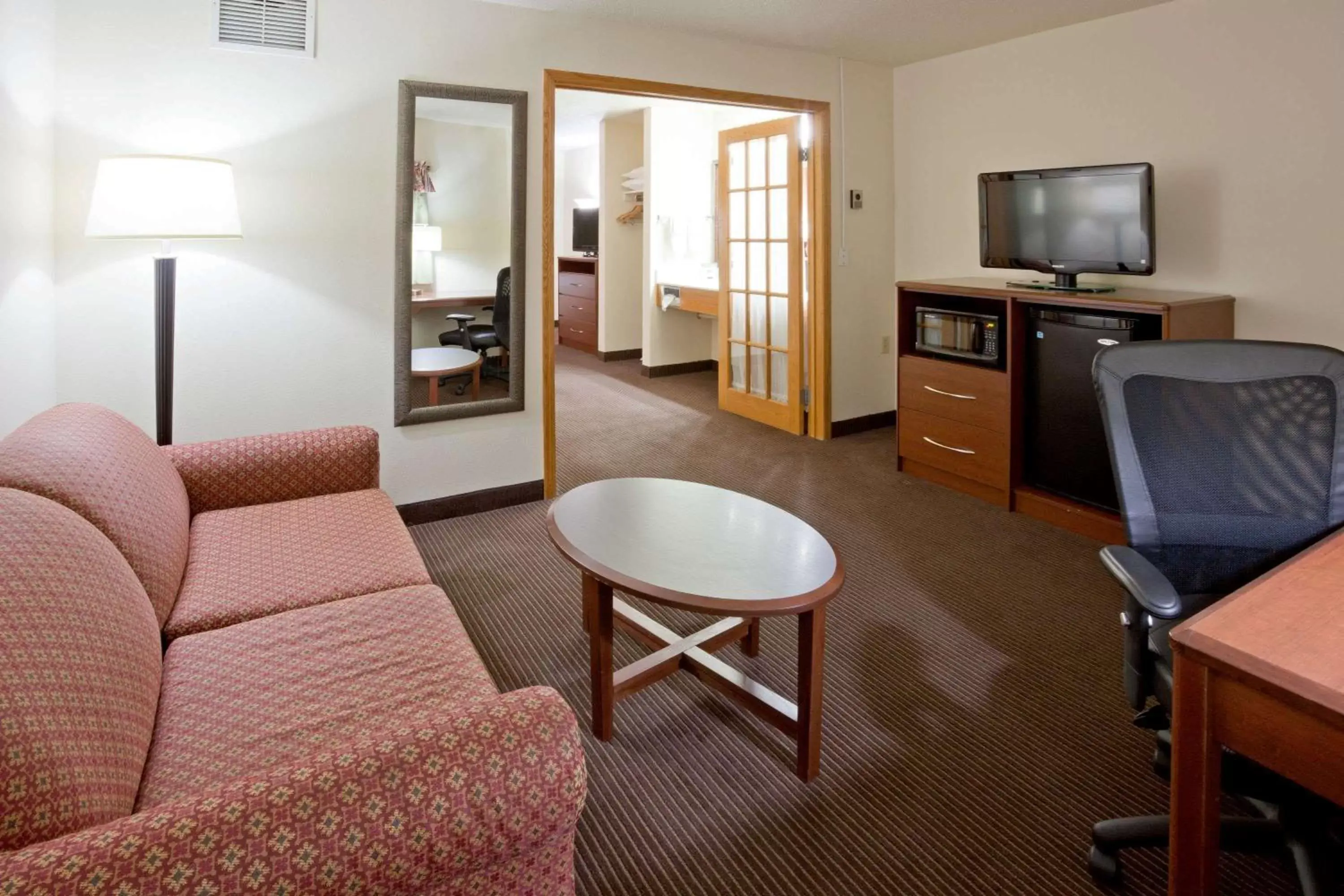 Photo of the whole room, TV/Entertainment Center in AmericInn by Wyndham Coon Rapids