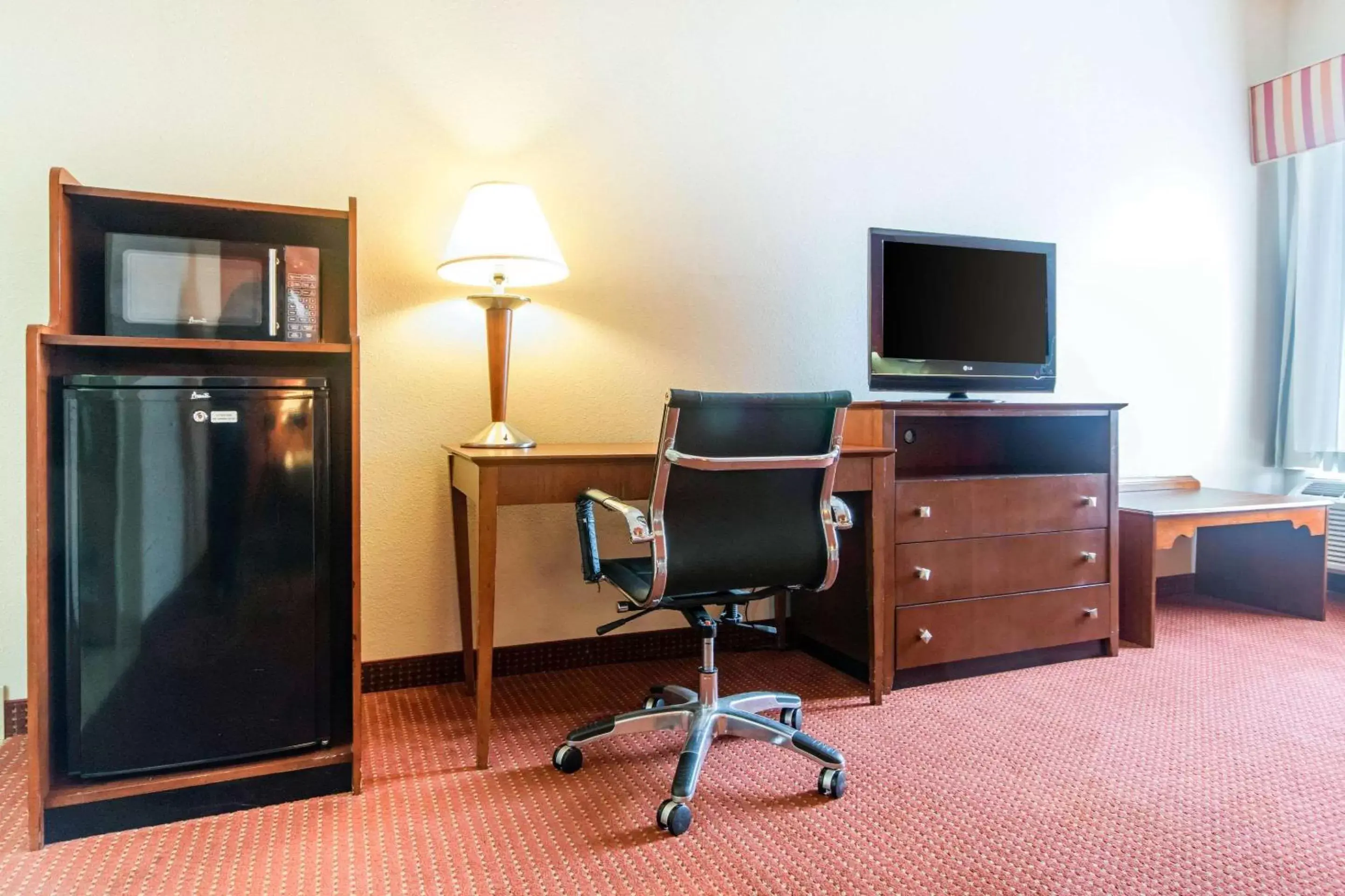 Photo of the whole room, TV/Entertainment Center in Quality Inn & Suites