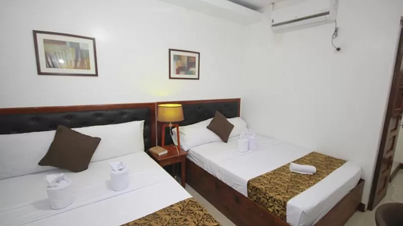 Bed in El Nido Royal Palm Inn