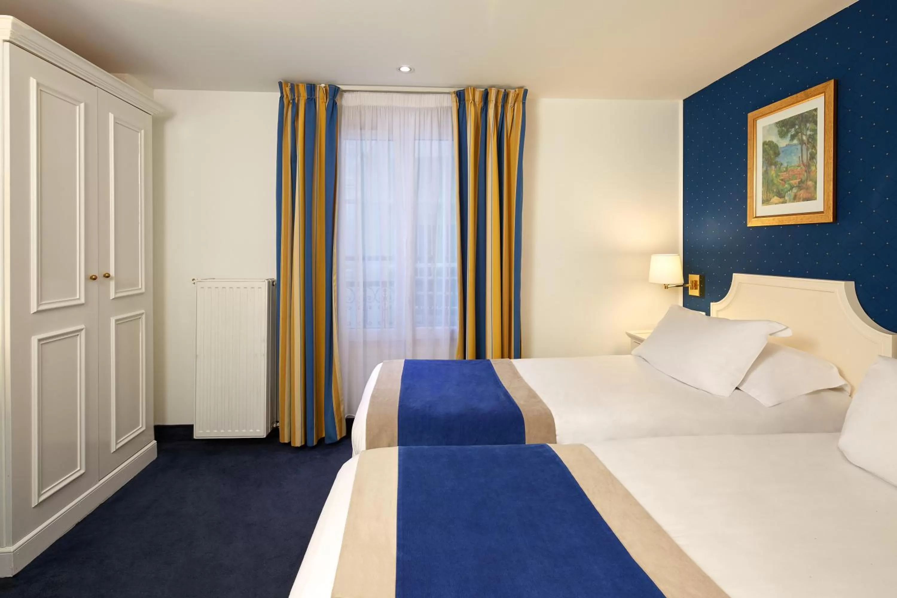 Bed in Austin's Arts Et Metiers Hotel