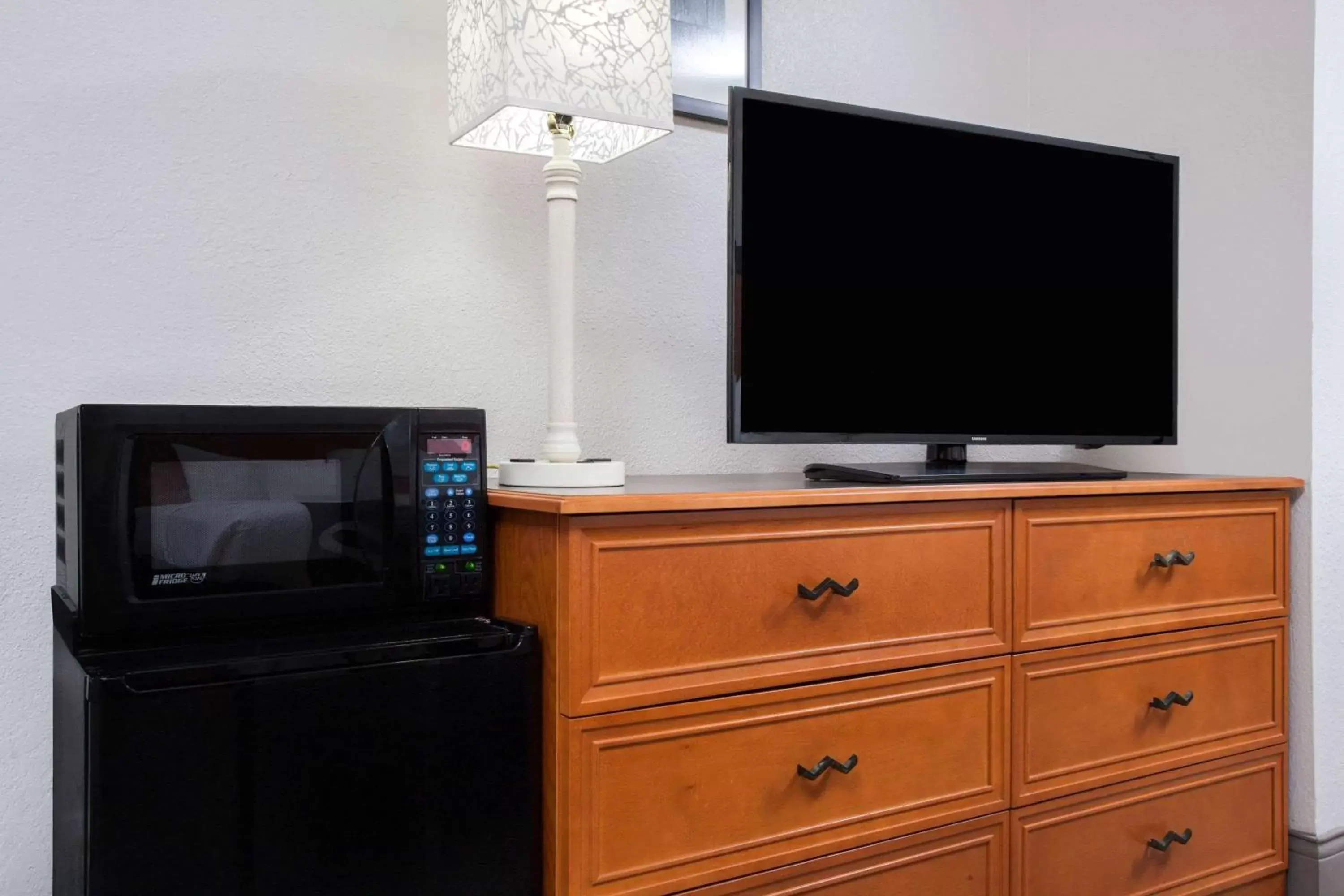 Photo of the whole room, TV/Entertainment Center in La Quinta Inn by Wyndham Fort Myers Central