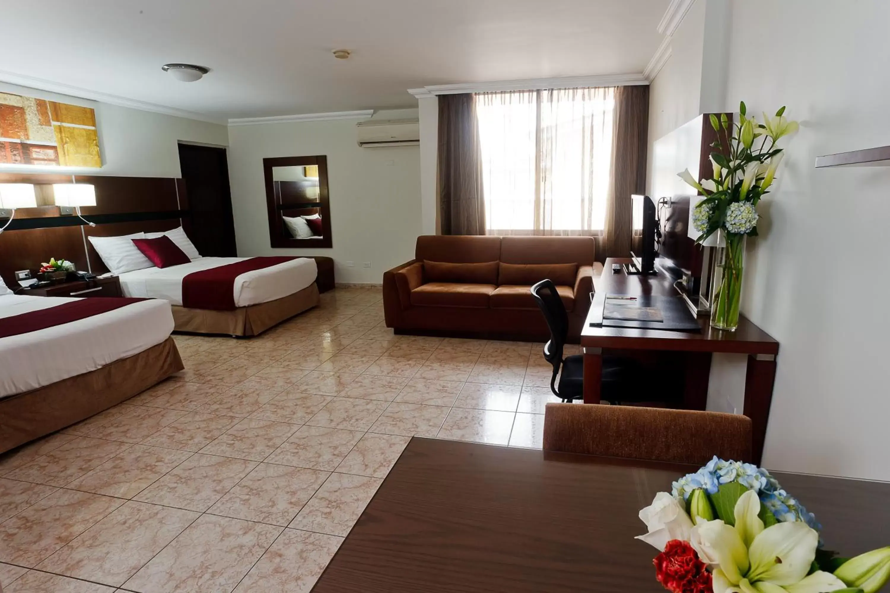 Bed, Seating Area in Hotel Coral Suites