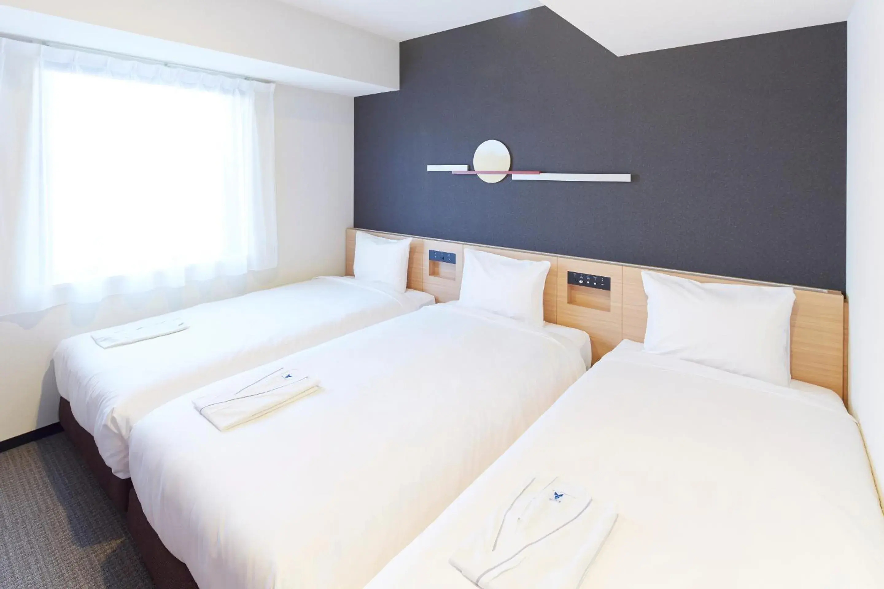 Bed in hotel MONday Tokyo Nishikasai