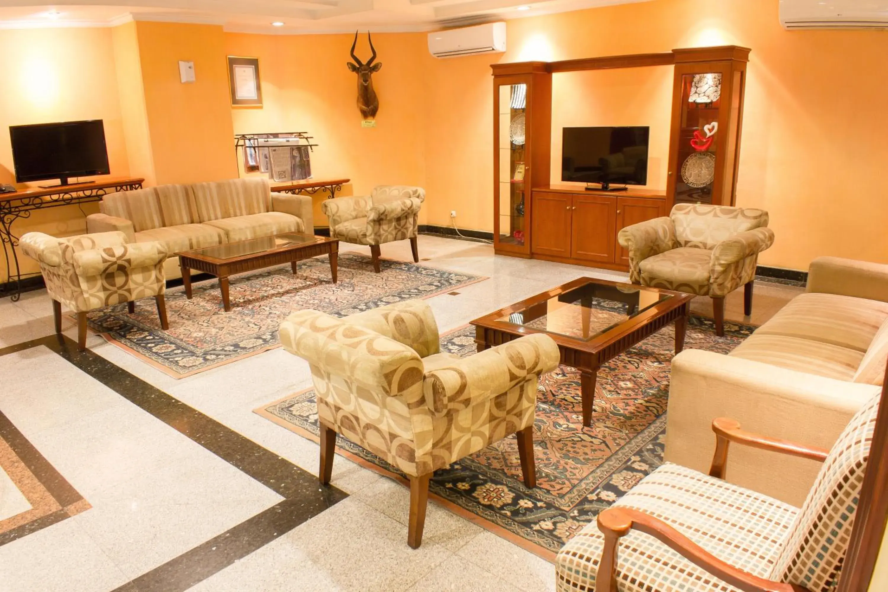 Communal lounge/ TV room, Seating Area in Travellers Suites Serviced Apartments