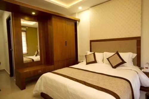 Bed in Glitz Inn Calicut