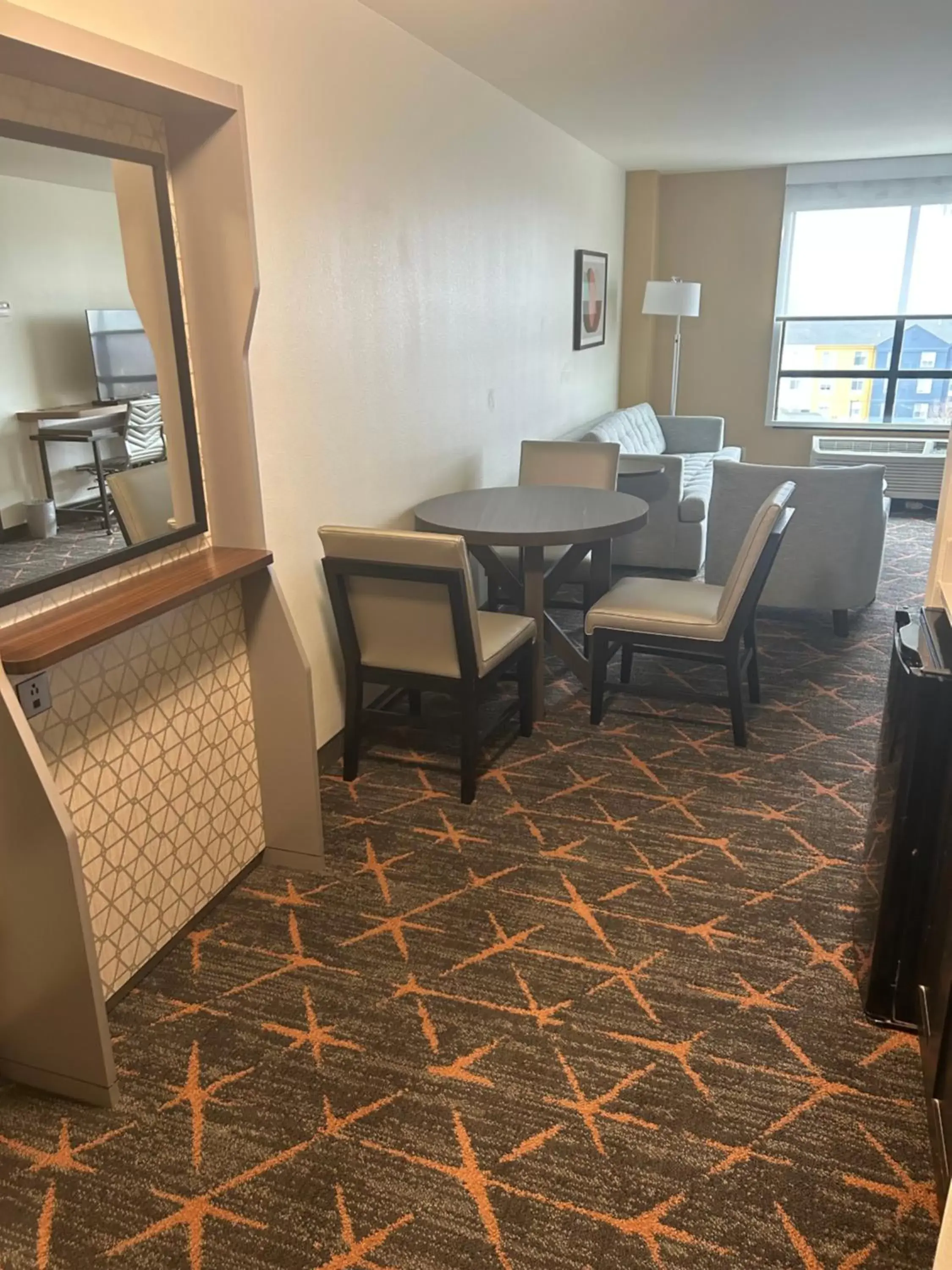 Living room, Dining Area in Holiday Inn Hotel & Suites Tulsa South, an IHG Hotel