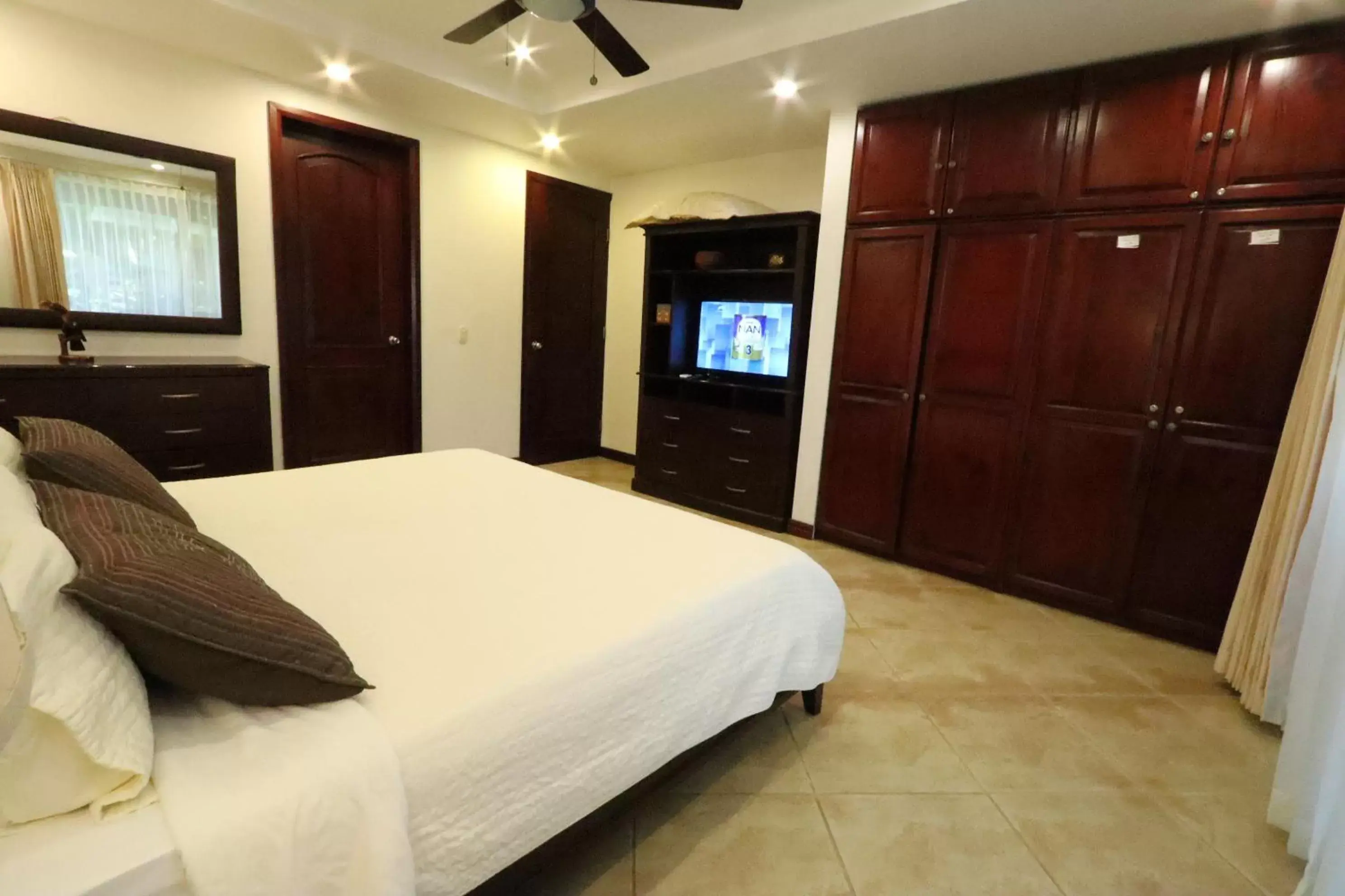 Bedroom, TV/Entertainment Center in Monte Carlo Luxury Condominiums