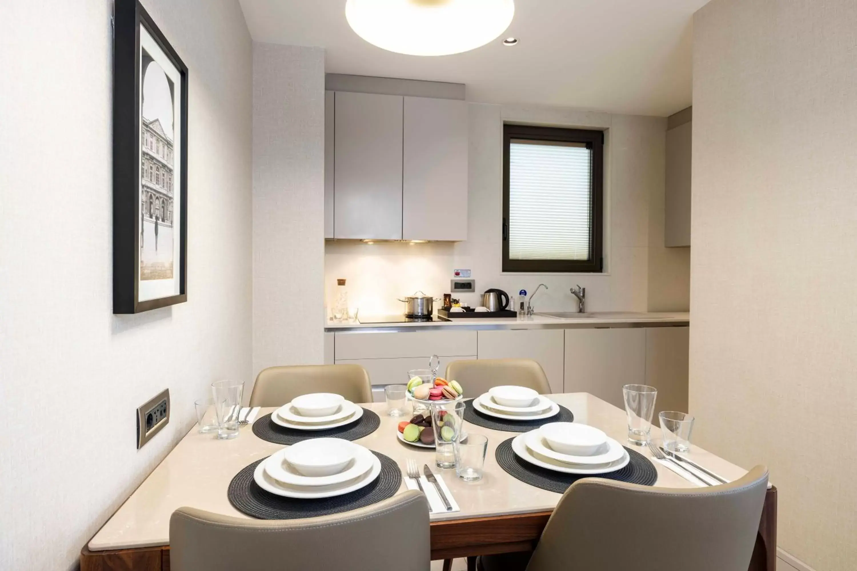 Kitchen or kitchenette, Dining Area in Tzl Suites Hotel