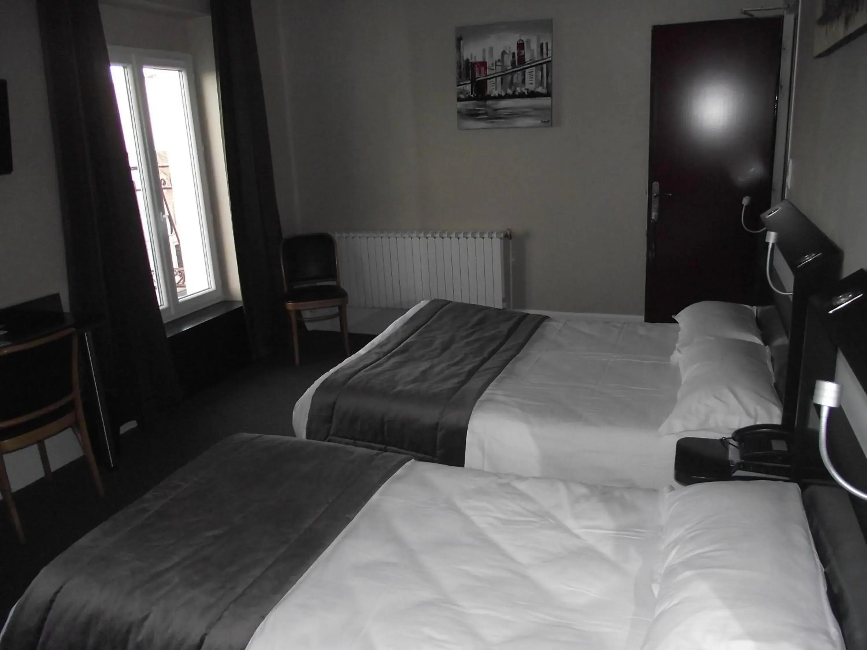 Bed in Logis Hotel des Bourbons