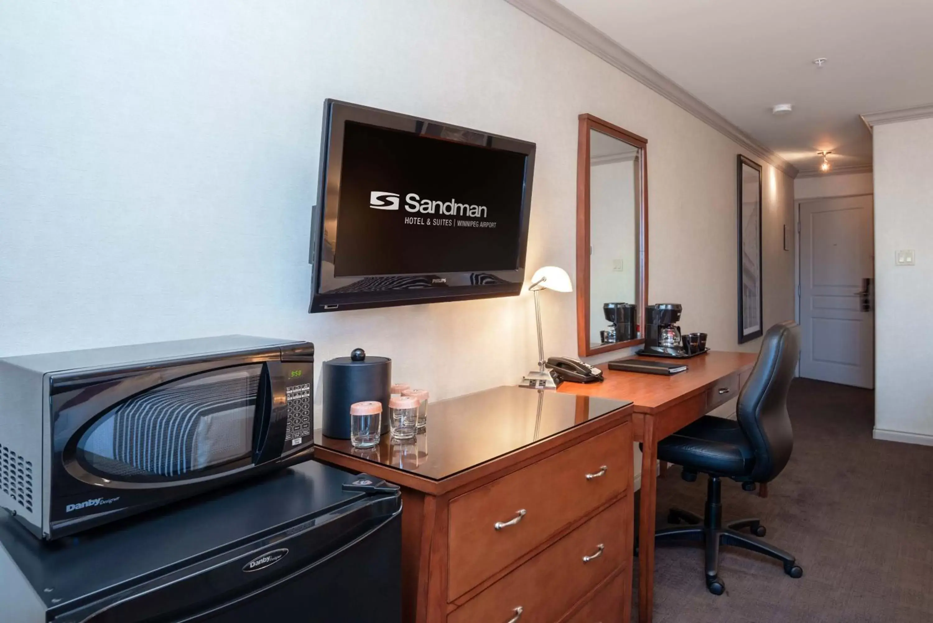 Photo of the whole room, TV/Entertainment Center in Sandman Hotel & Suites Winnipeg Airport