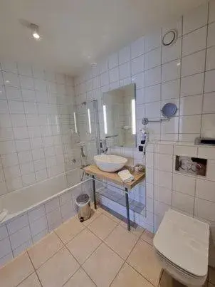 Bathroom in Brit Hotel Confort La Ferme du Pape