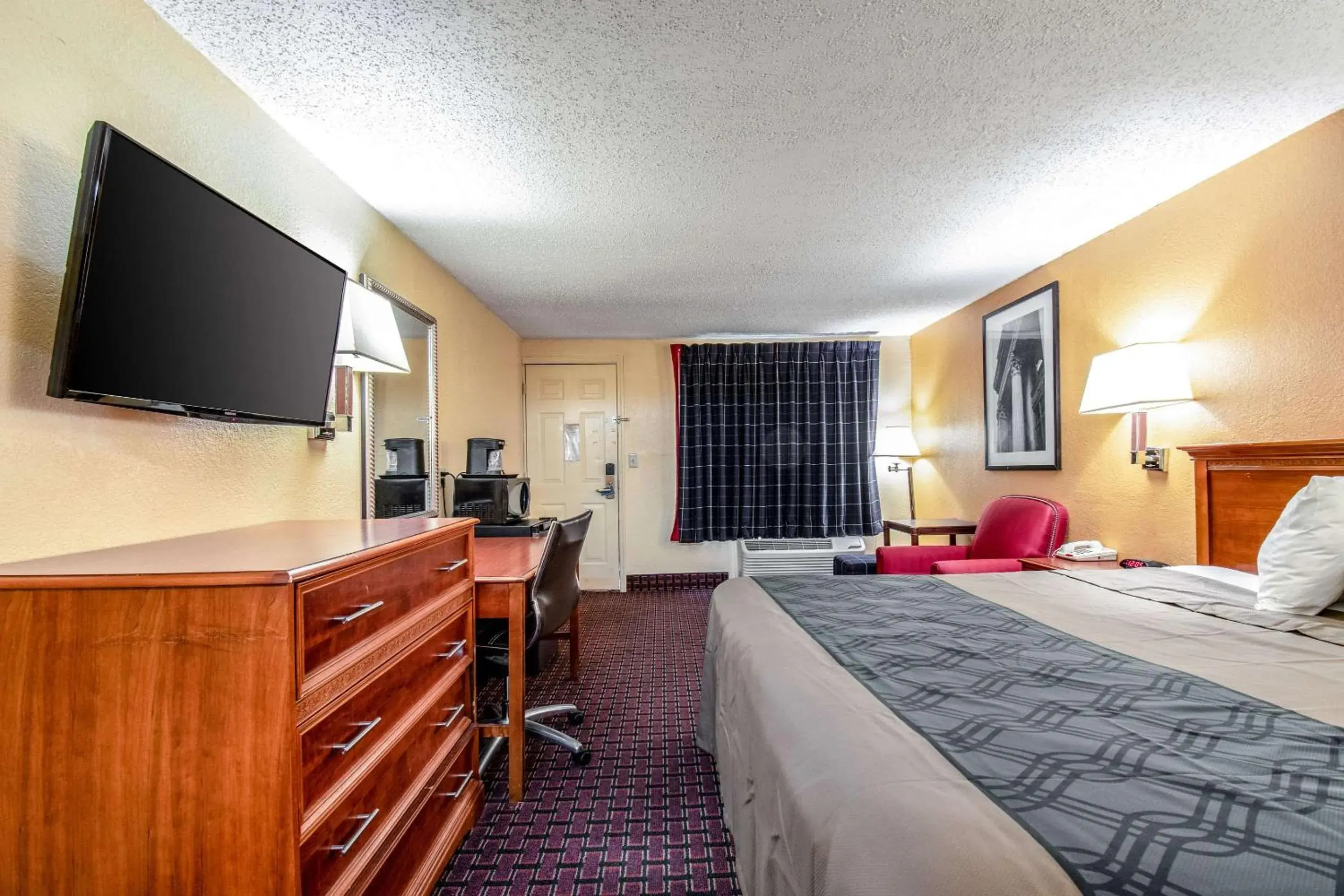 Photo of the whole room, TV/Entertainment Center in Rodeway Inn