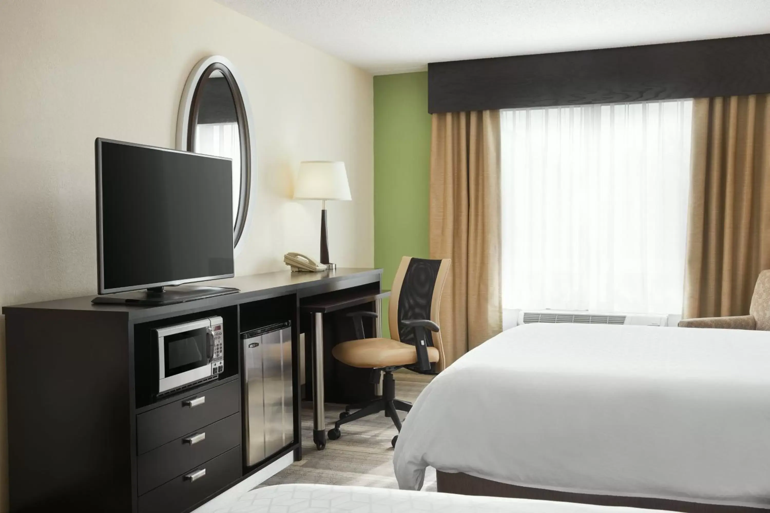 Photo of the whole room, TV/Entertainment Center in Holiday Inn Express & Suites I-26 & Us 29 At Westgate Mall, an IHG Hotel