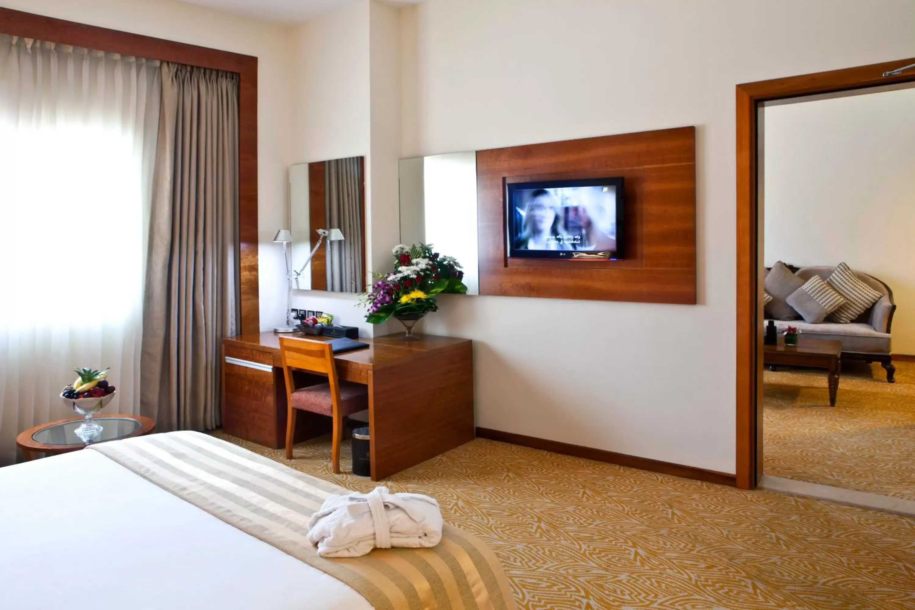 Bedroom, TV/Entertainment Center in Landmark Grand Hotel