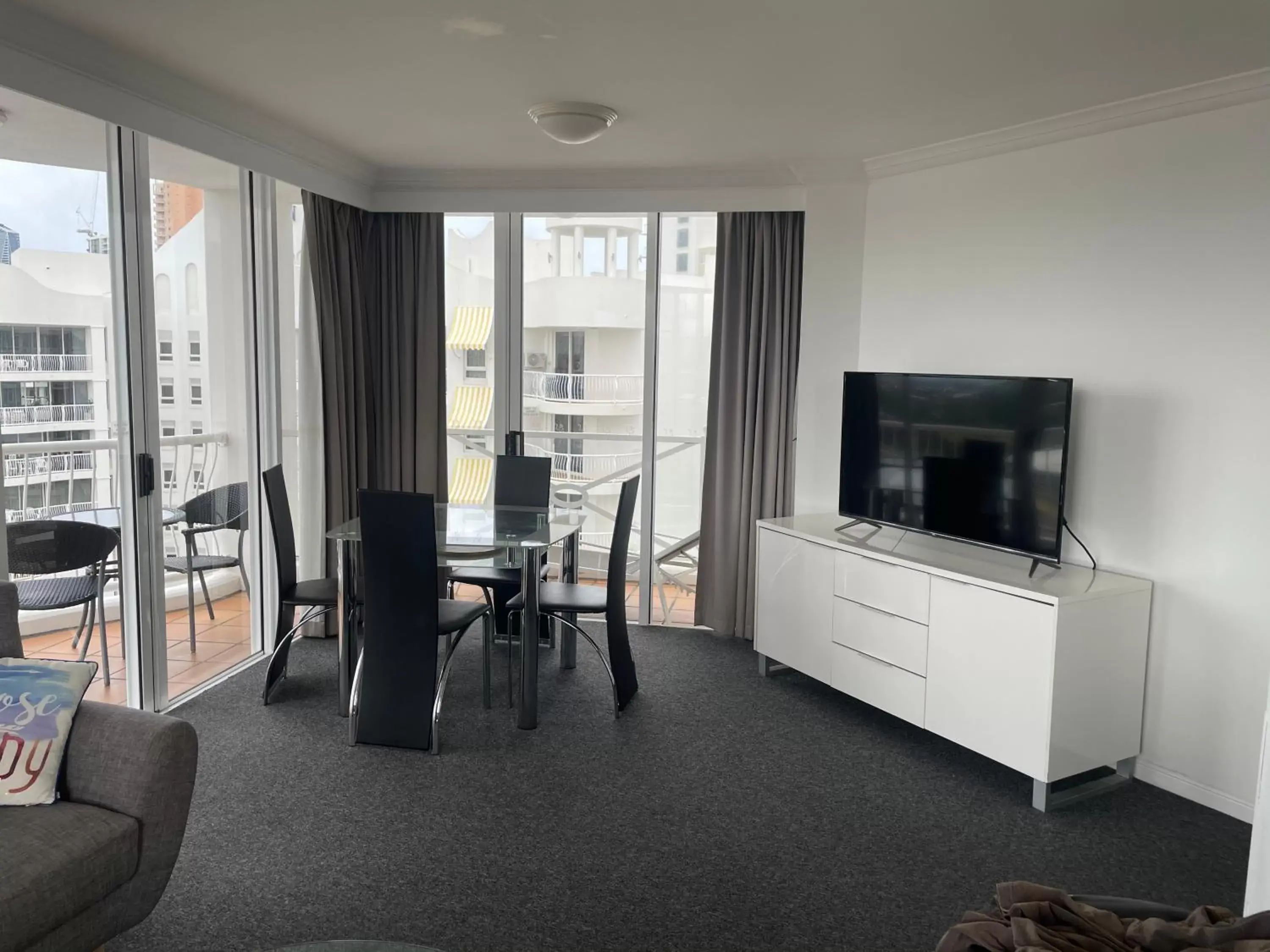 Dining area, TV/Entertainment Center in Broadbeach Holiday Apartments