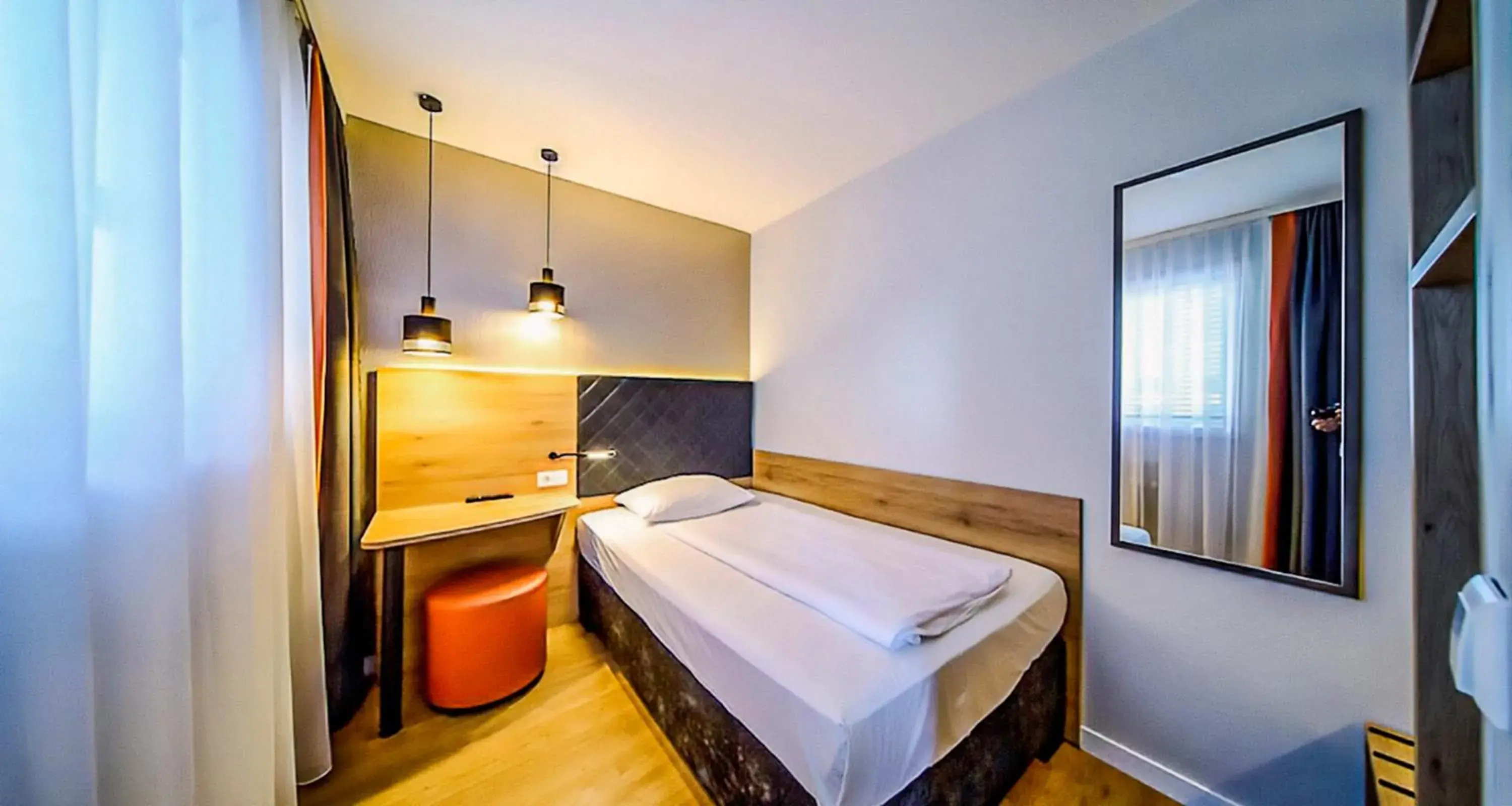 Photo of the whole room, Bed in Novum Hotel Rieker Stuttgart Hauptbahnhof   