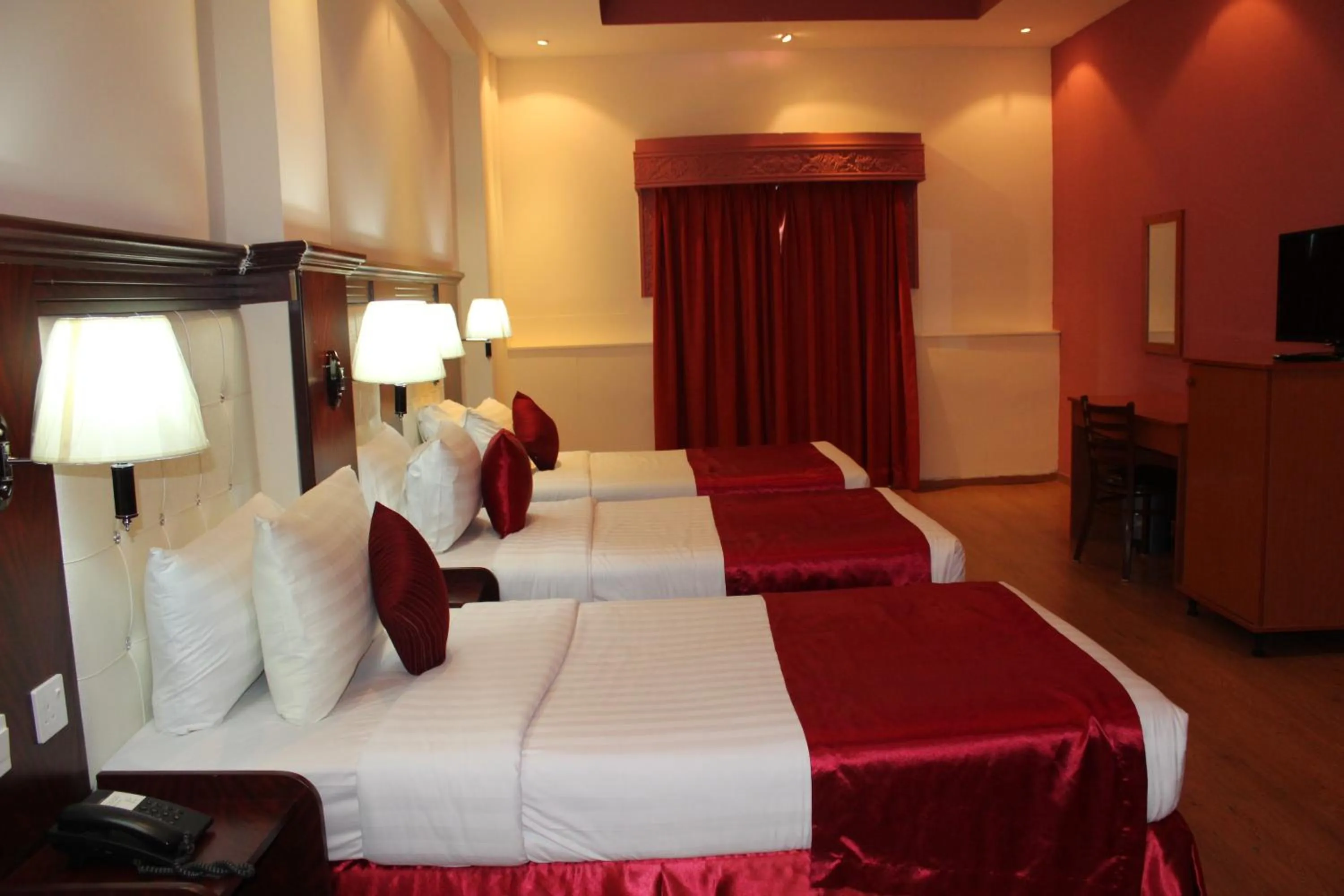 Bed in Grand Nova Hotel