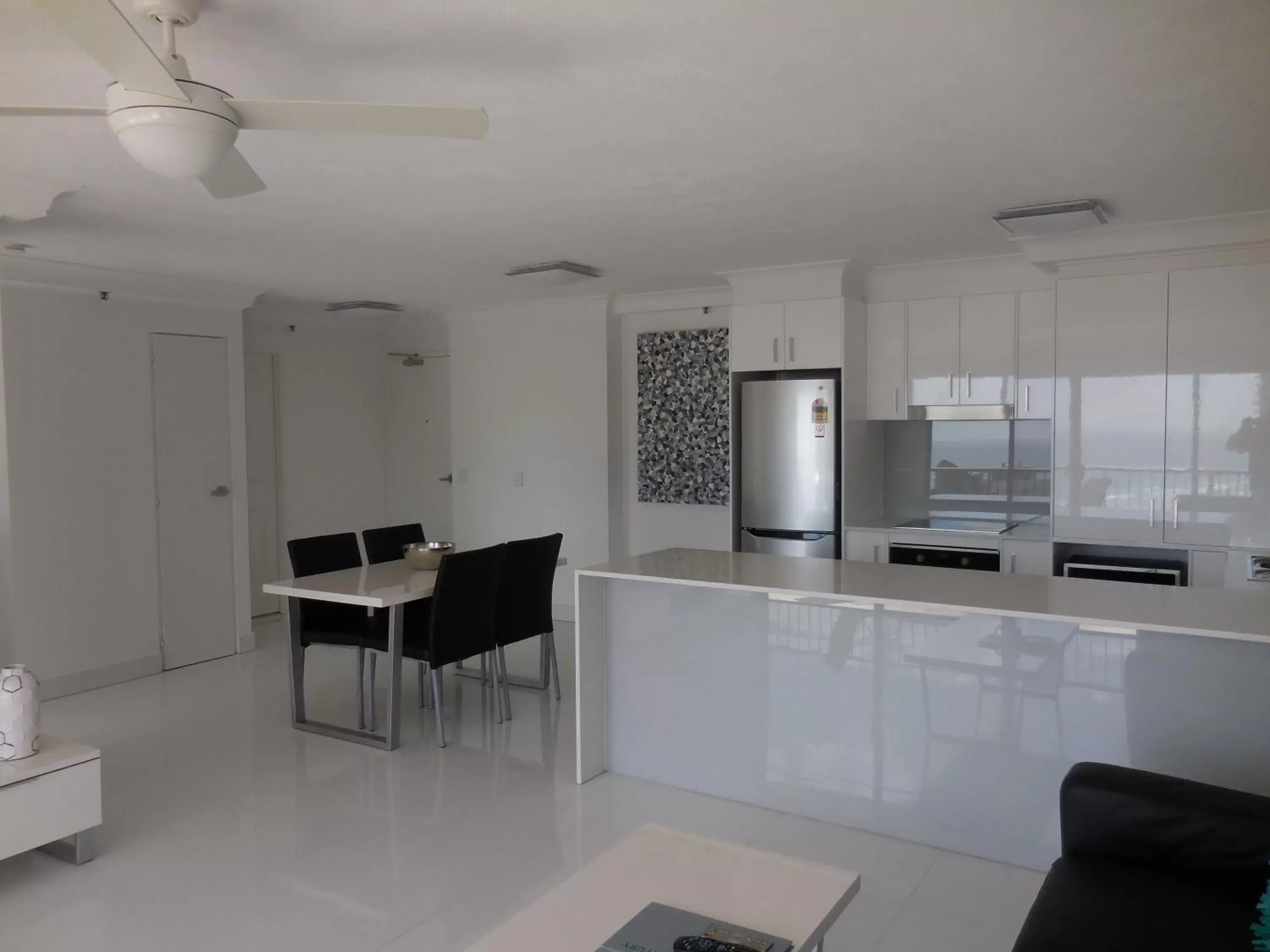 Living room, Kitchen/Kitchenette in Surfers Century Oceanside Apartments