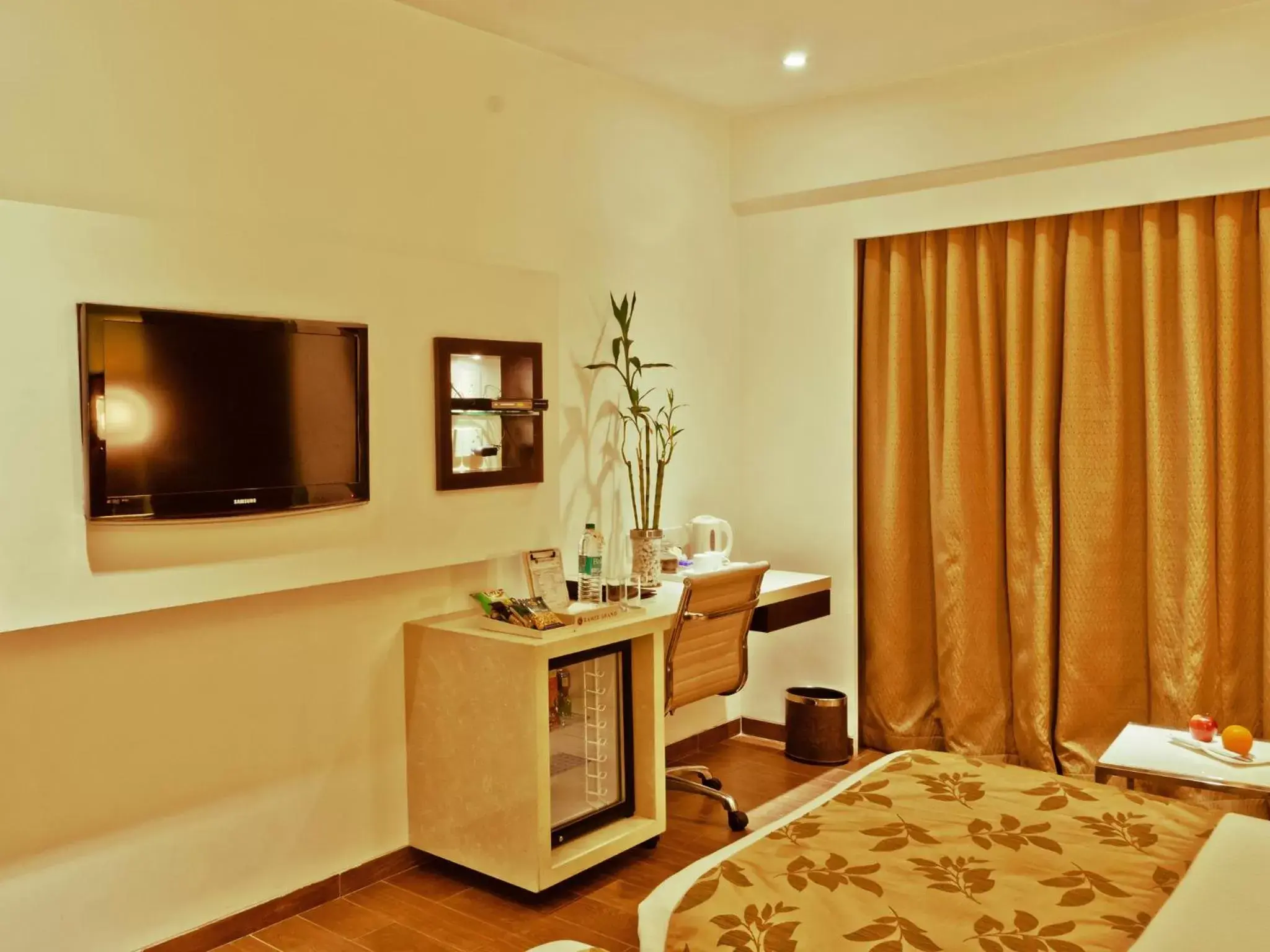 Photo of the whole room, TV/Entertainment Center in Ramee Grand Hotel and Spa, Pune