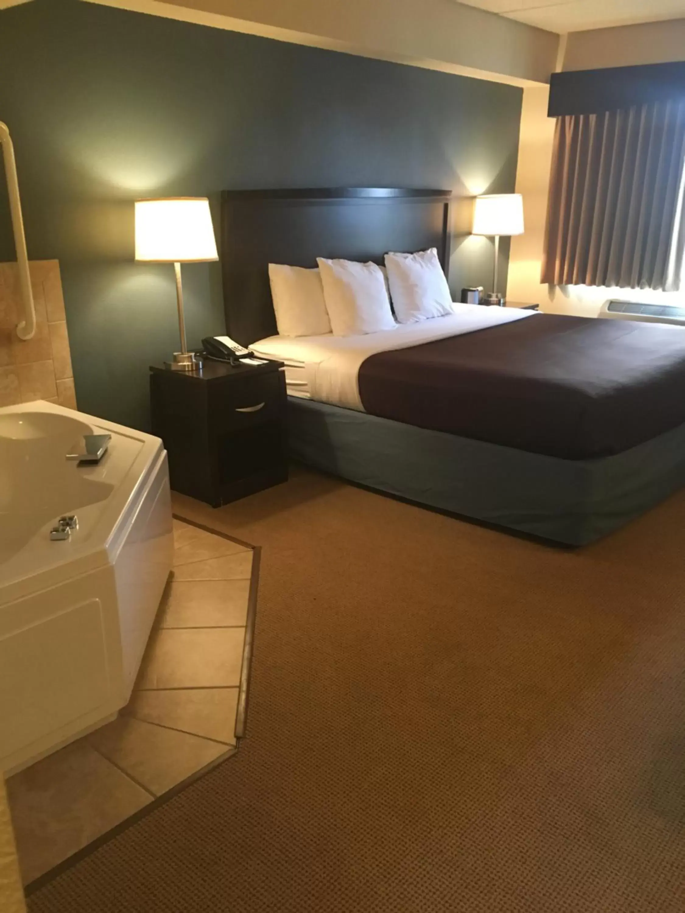 Bed in AmericInn by Wyndham Monmouth