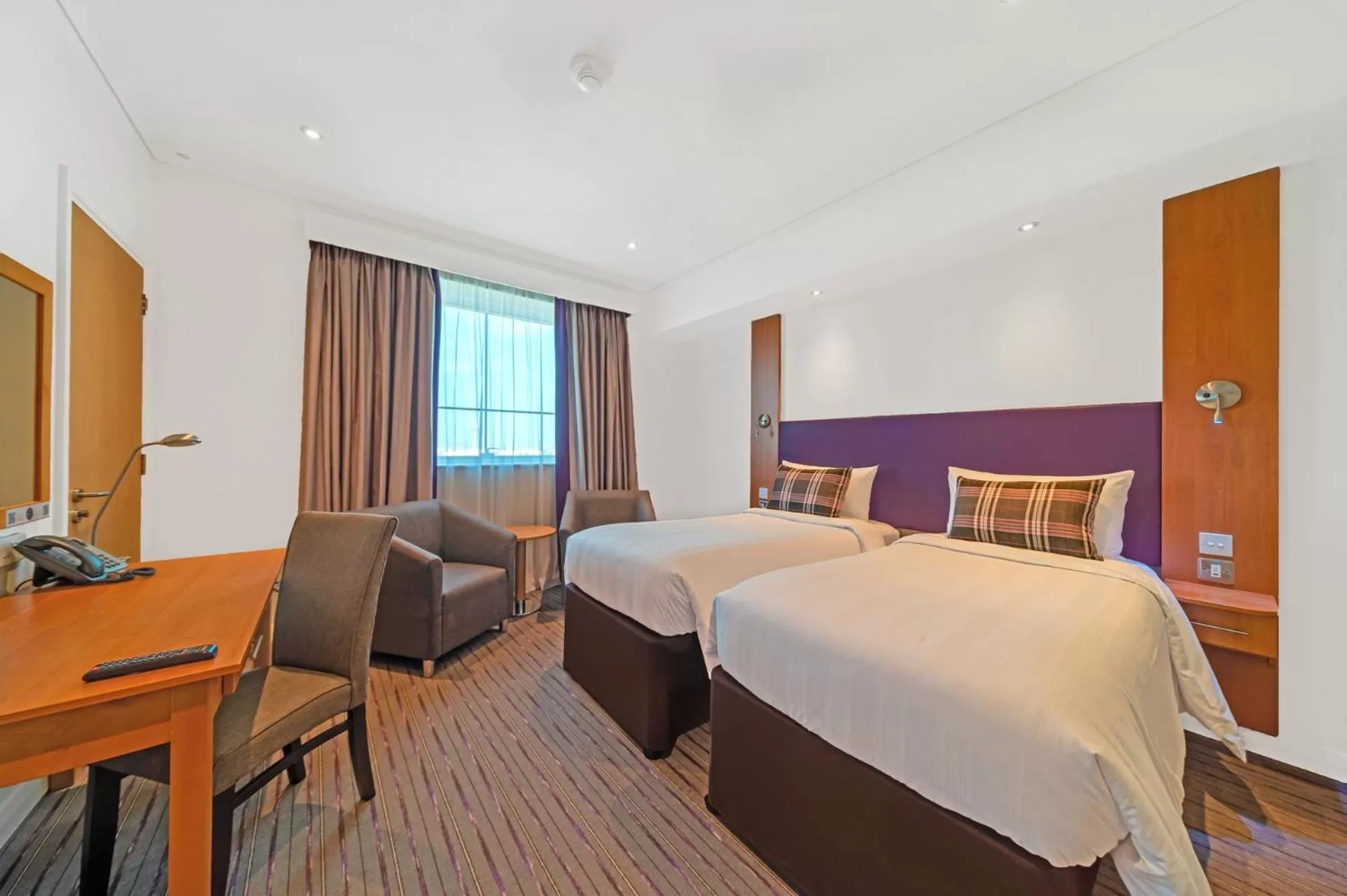 Seating area, Bed in Premier Inn Dubai Investments Park - An Emirates Group Company