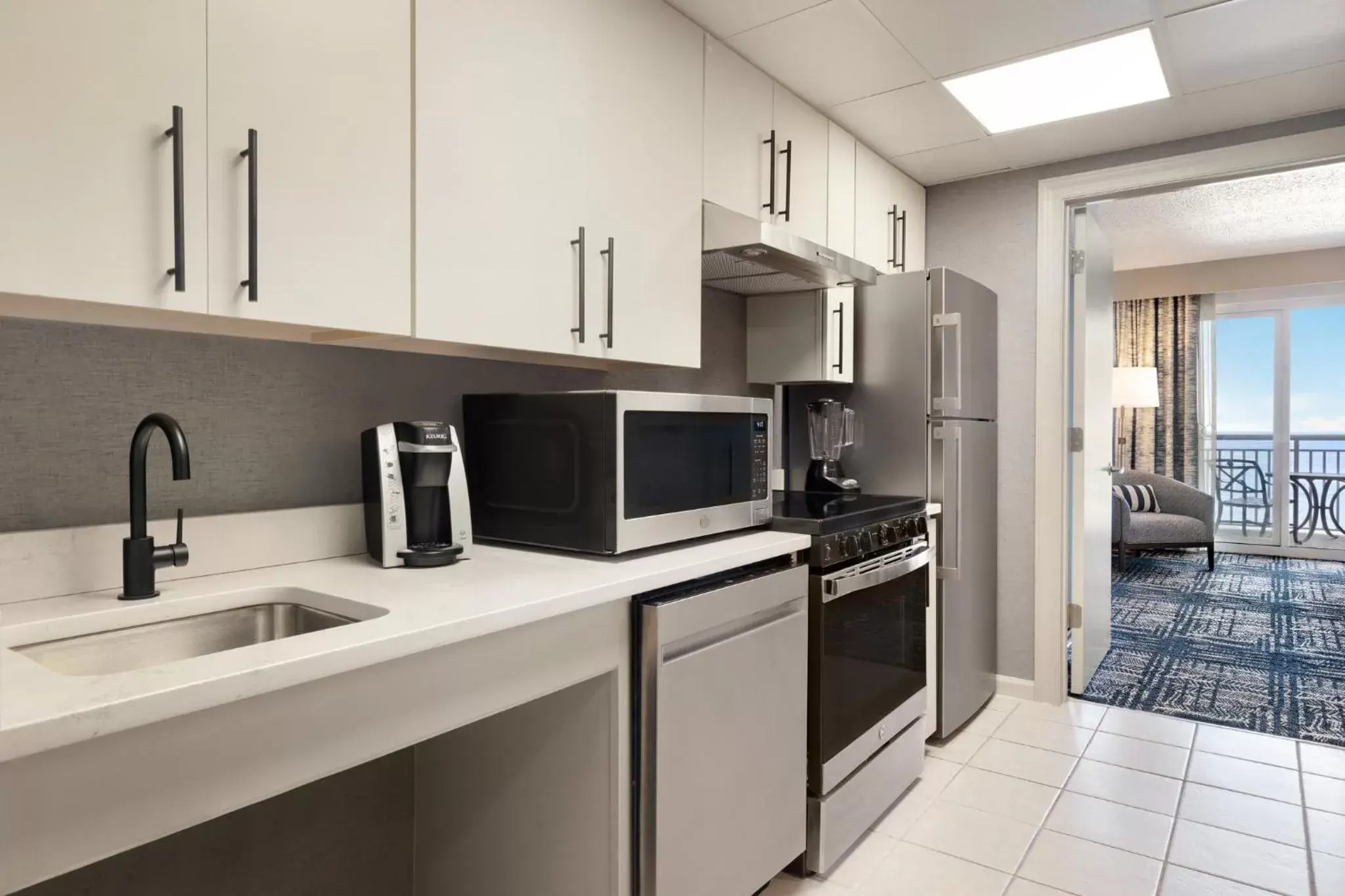 Bedroom, Kitchen/Kitchenette in Holiday Inn & Suites Ocean City, an IHG Hotel