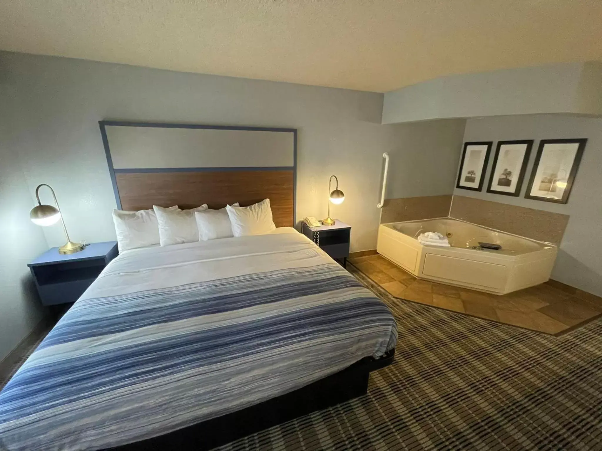 Bed in AmericInn by Wyndham Sayre