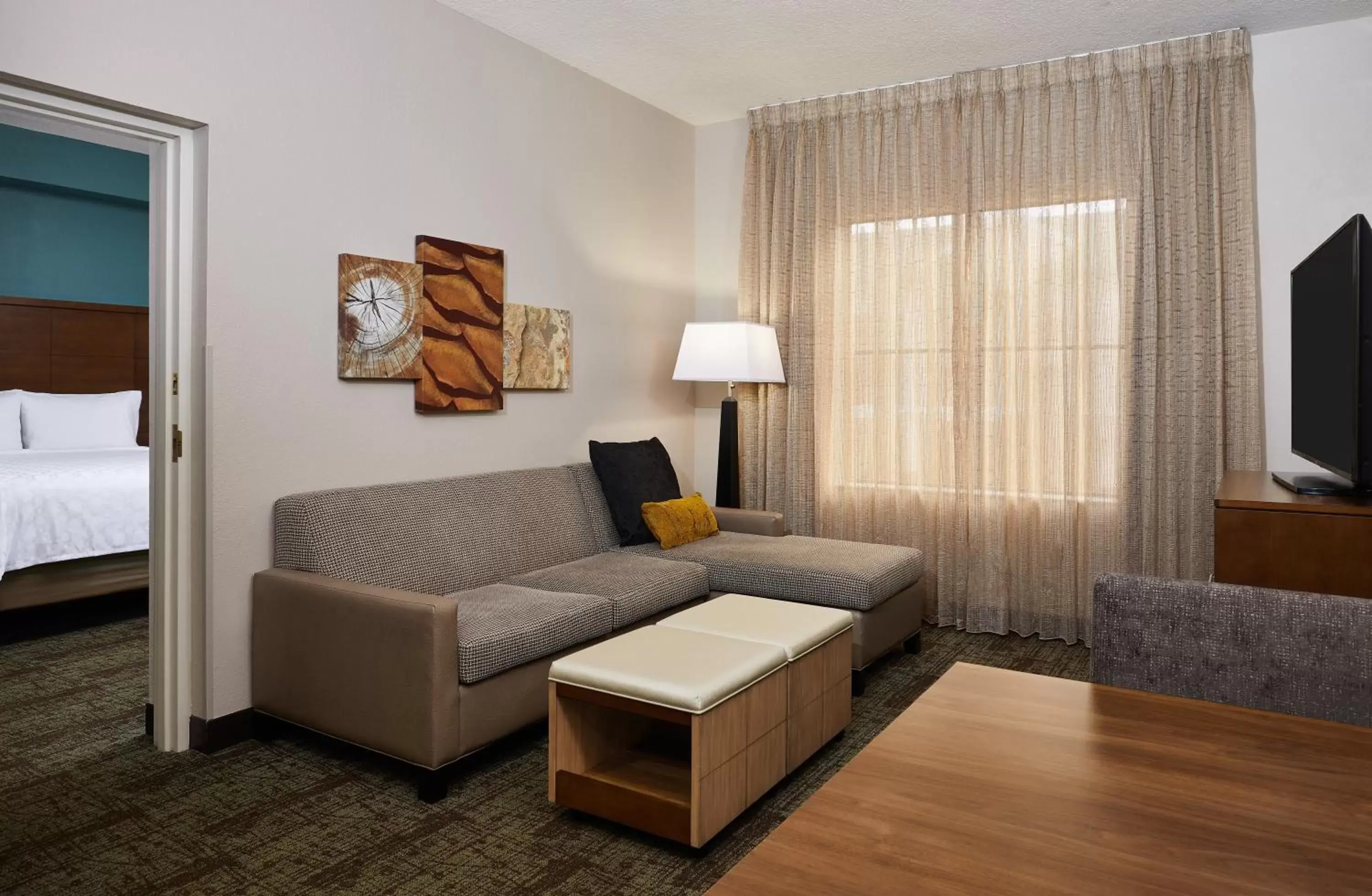Bedroom, Seating Area in Staybridge Suites Orlando South, an IHG Hotel