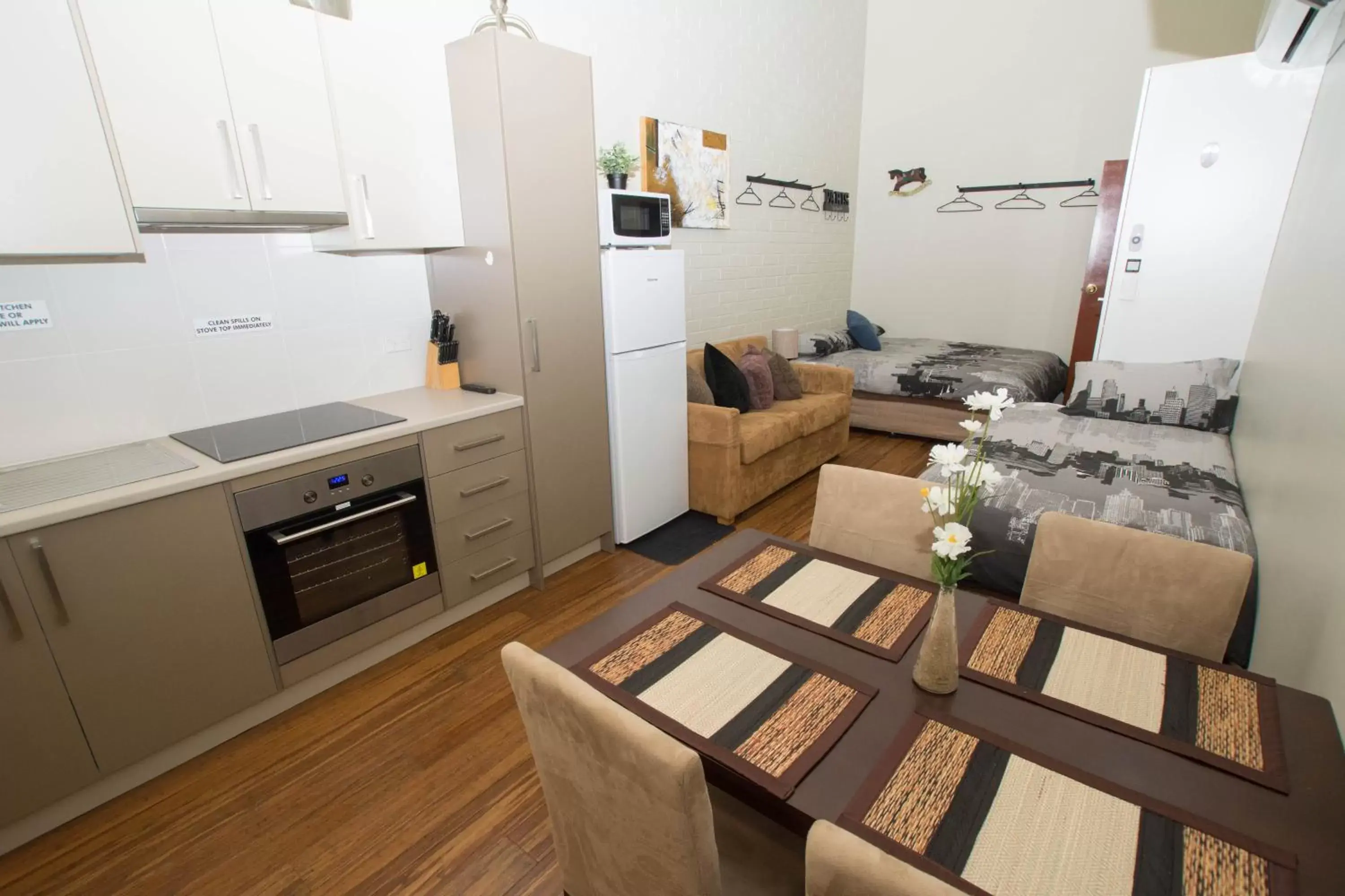 Bed, Kitchen/Kitchenette in Westside Studio Apartments