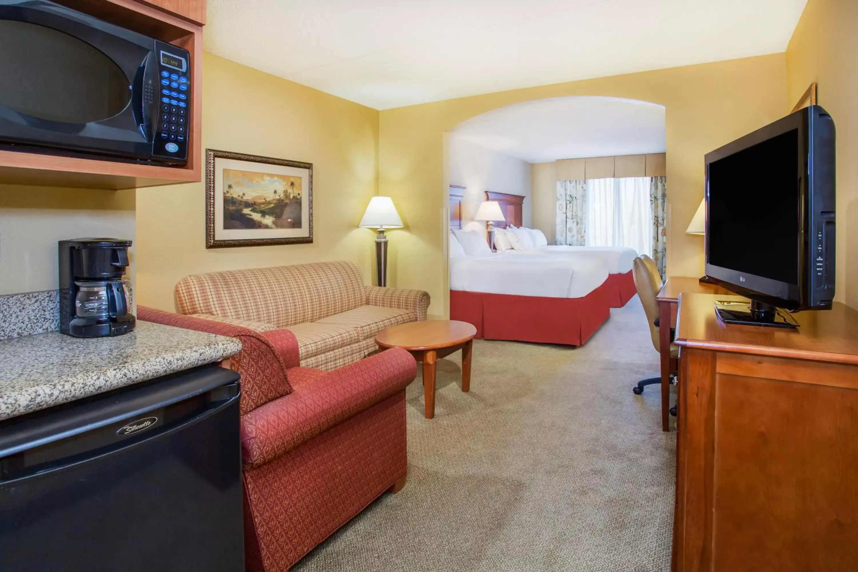 Photo of the whole room, TV/Entertainment Center in Holiday Inn Express & Suites Bloomington, an IHG Hotel