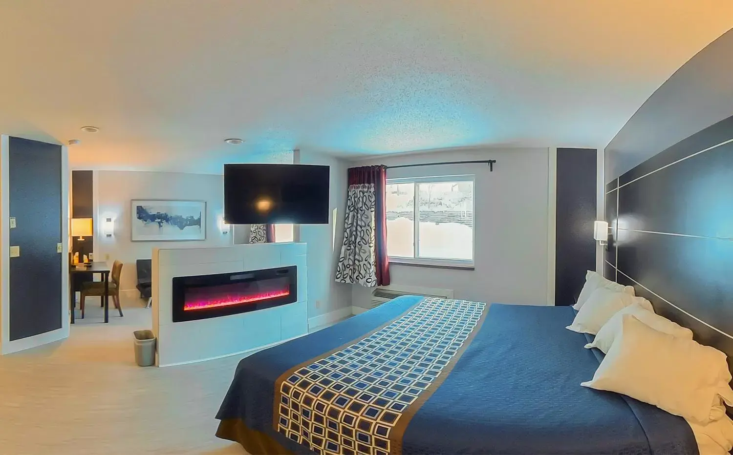 Bed, TV/Entertainment Center in Coratel Inn & Suites by Jasper Hastings