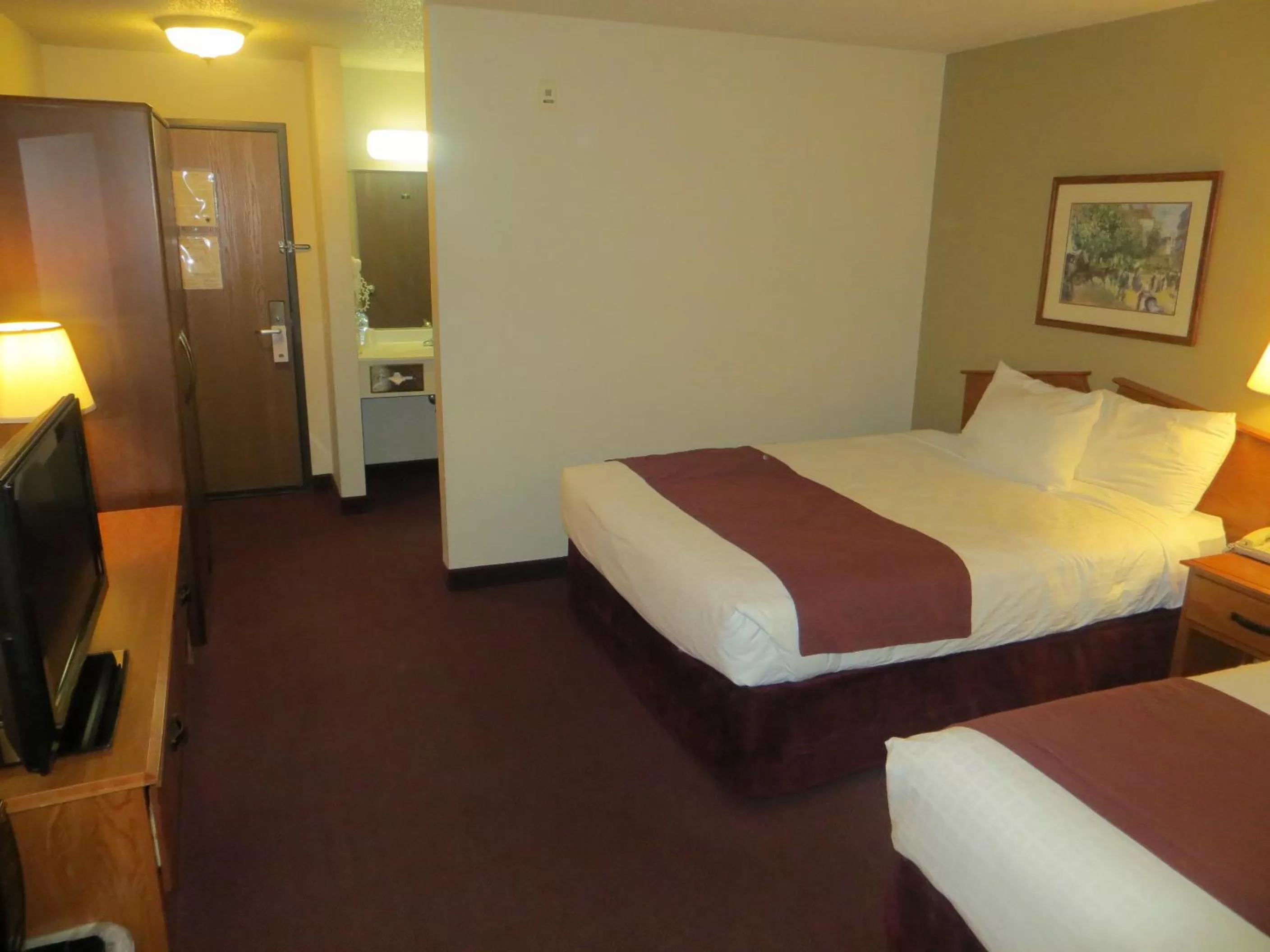 Bed in AmericInn by Wyndham Manitowoc