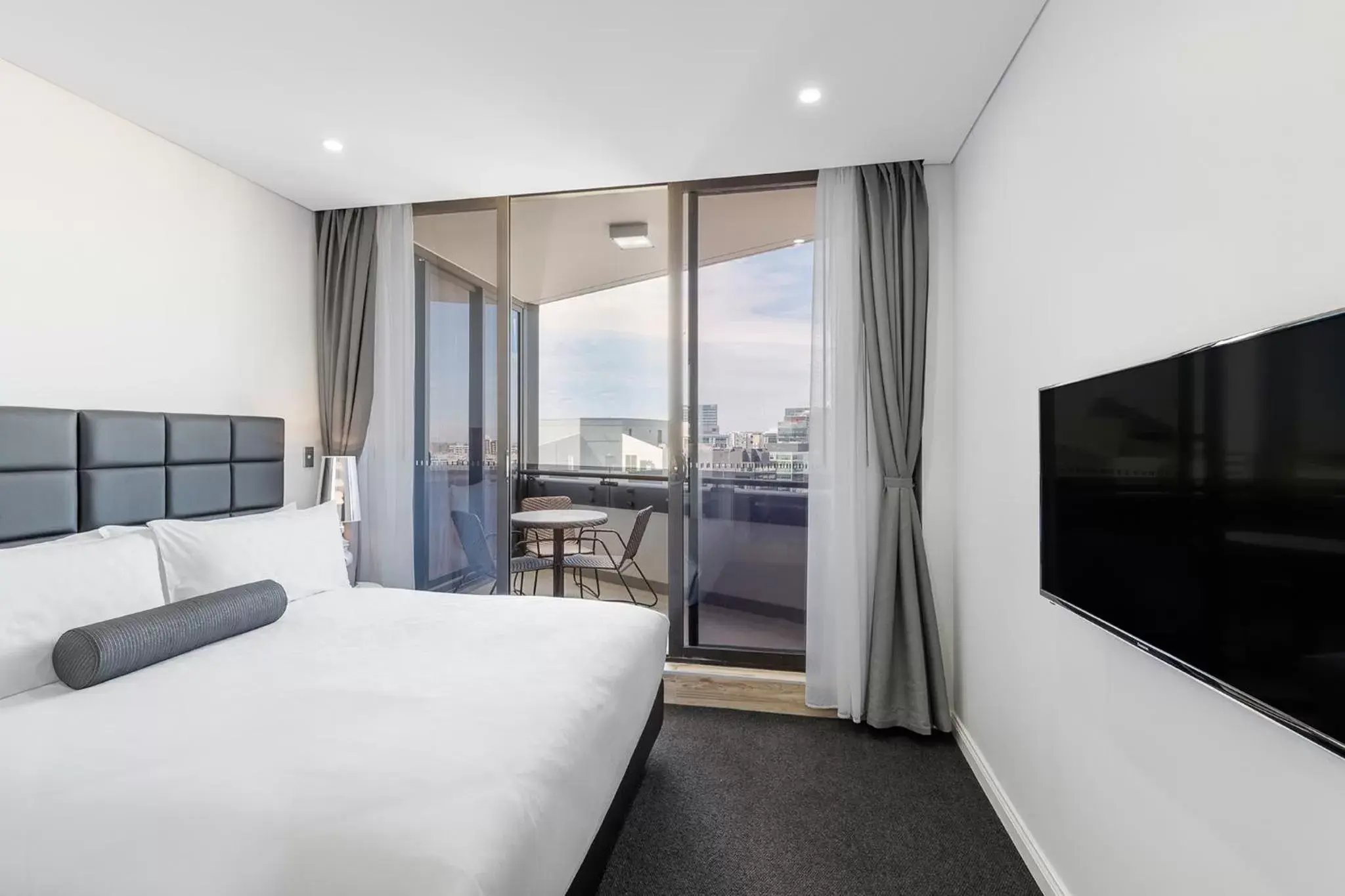 Bed, TV/Entertainment Center in Meriton Suites Church Street, Parramatta