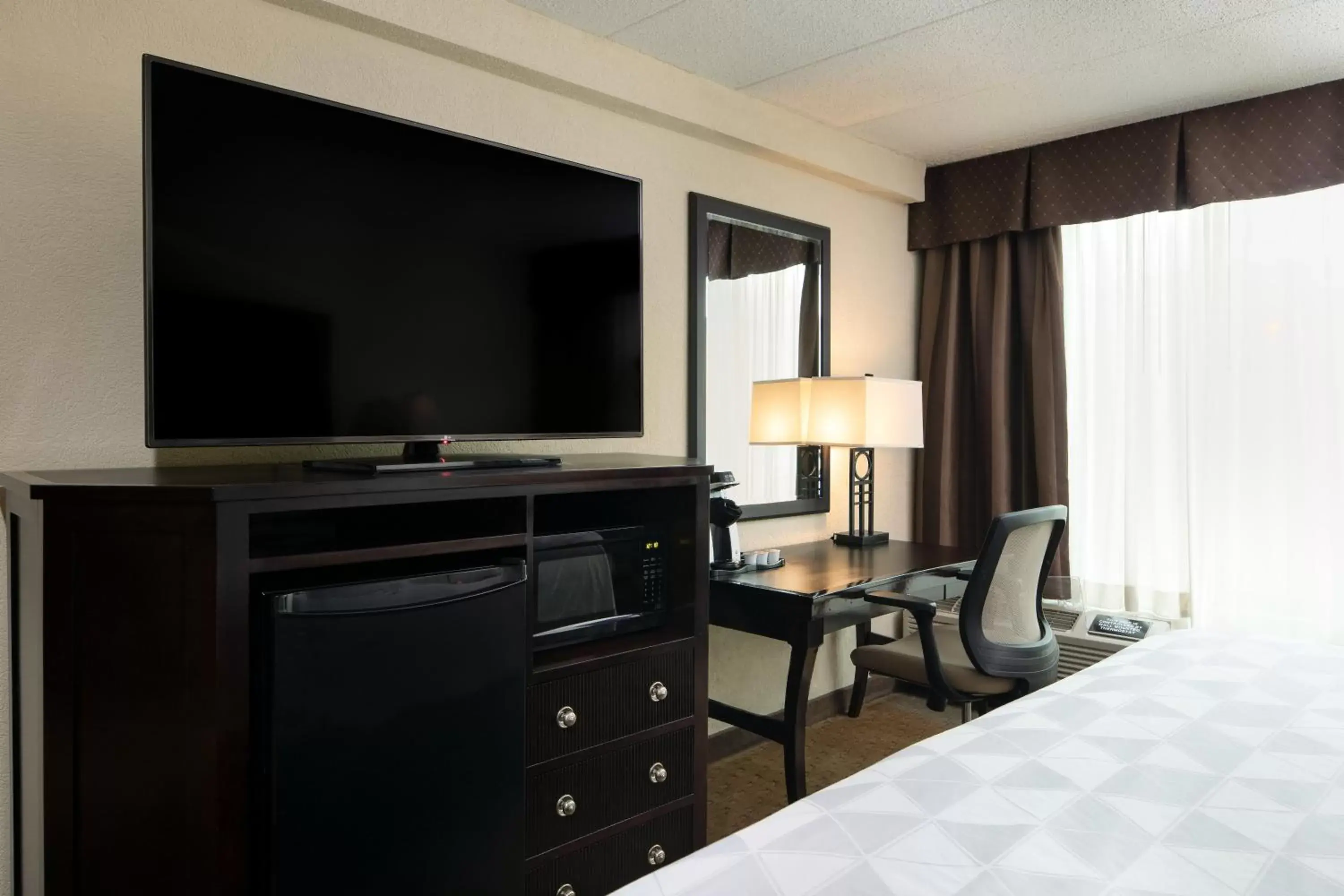 Photo of the whole room, TV/Entertainment Center in Holiday Inn and Suites Charleston West, an IHG Hotel