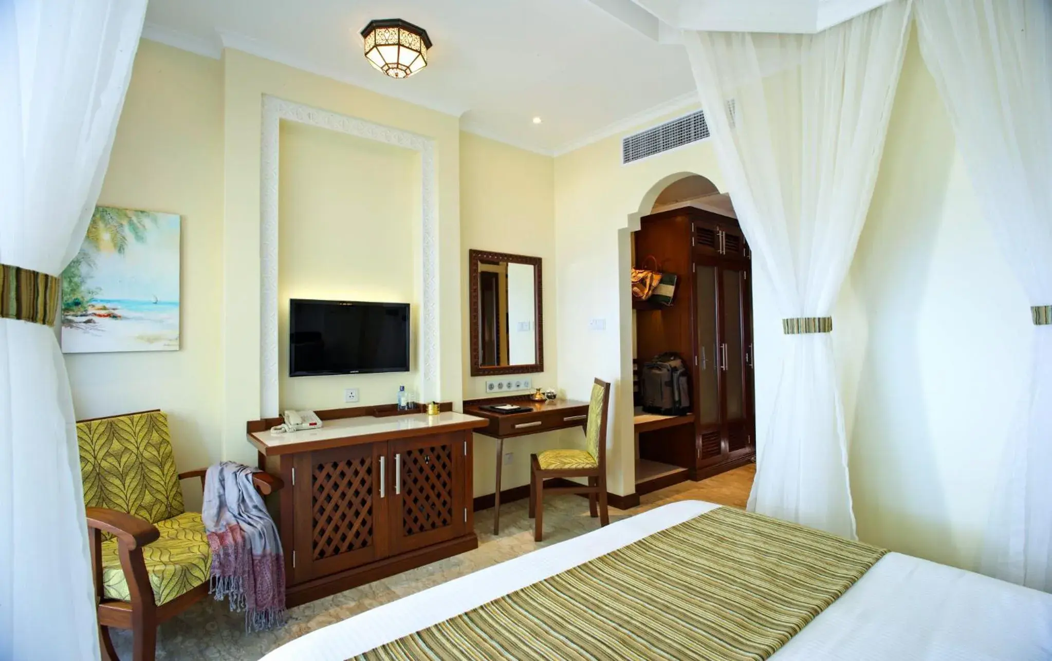 Bed, TV/Entertainment Center in Sarova Whitesands Beach Resort & Spa