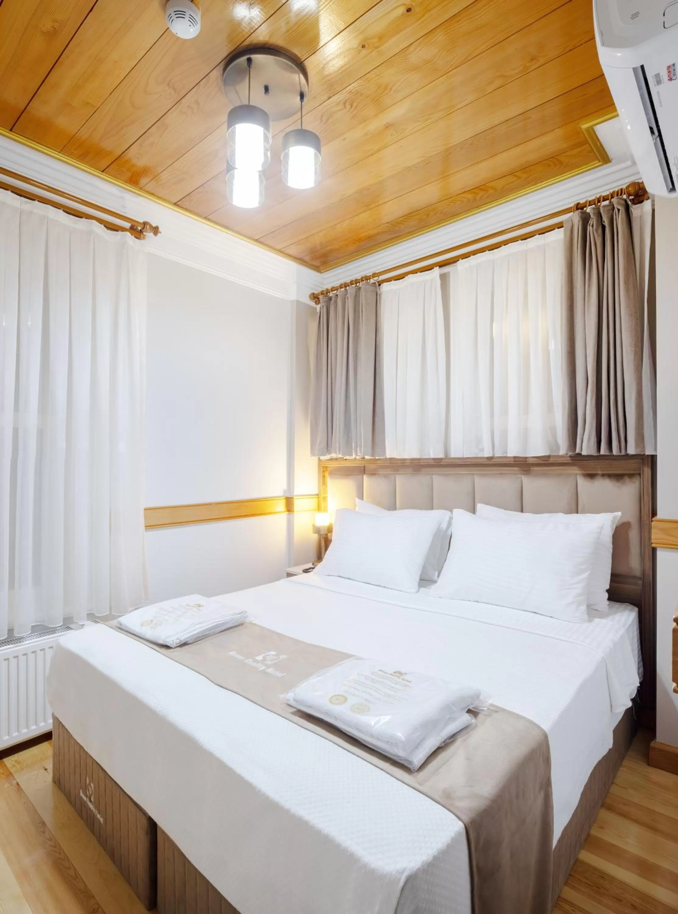 Bed in HOME QUALITY HOTEL