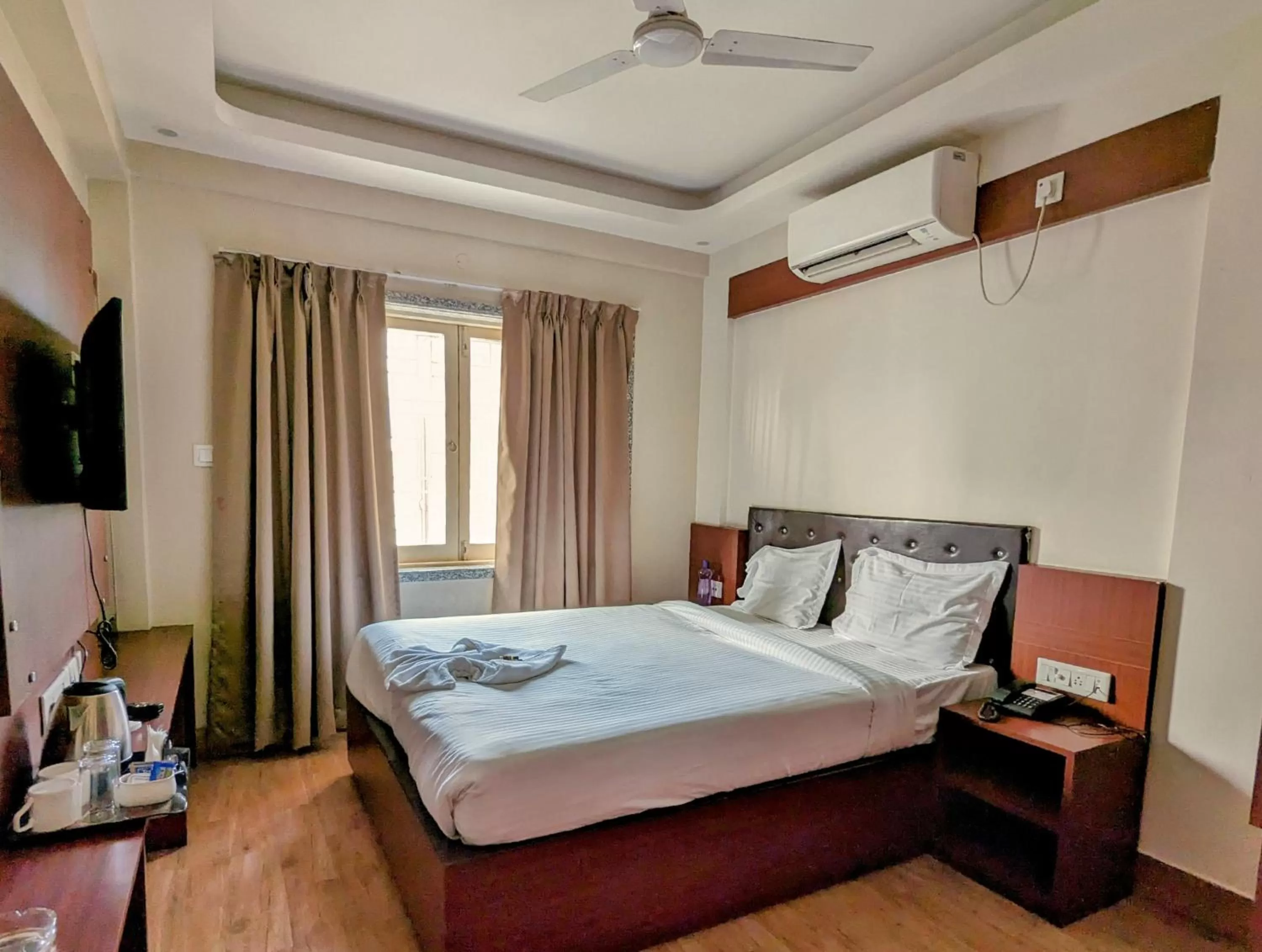 Bed in The Aster Enclave Hotel