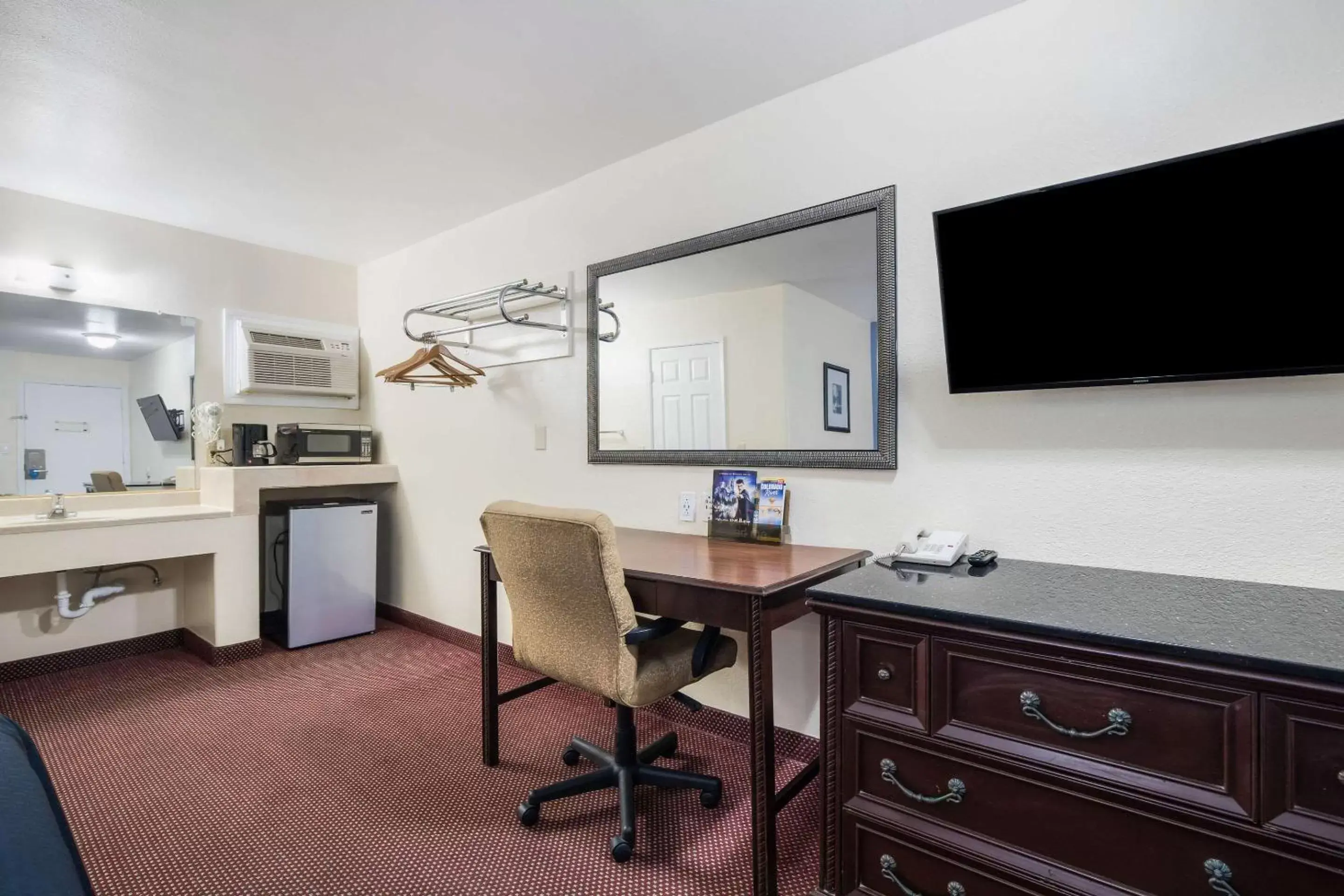 Photo of the whole room, TV/Entertainment Center in Rodeway Inn & Suites