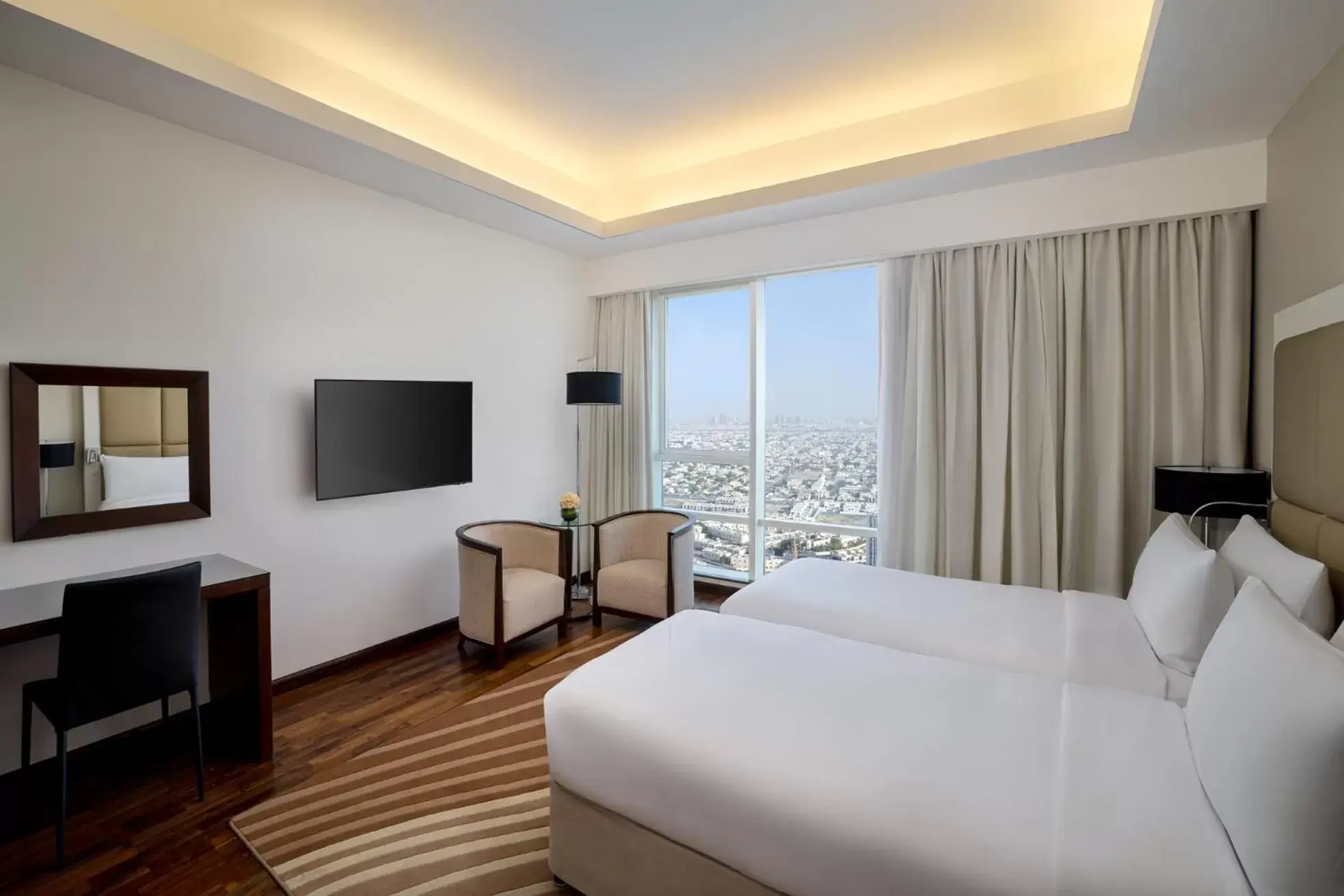 Bed, TV/Entertainment Center in La Suite Dubai Hotel & Apartments