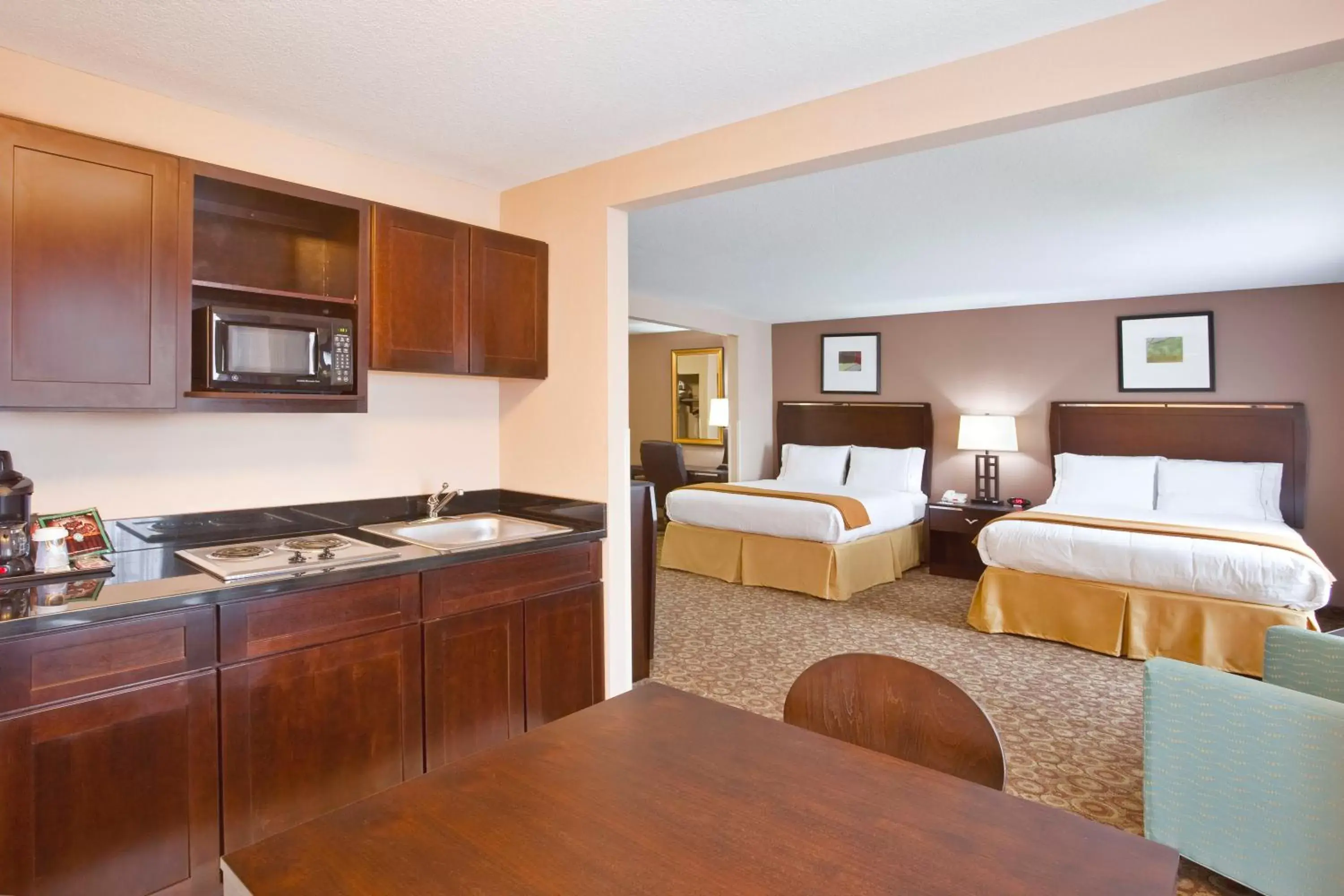 Bedroom, Kitchen/Kitchenette in Holiday Inn Express Hotel & Suites Van Wert, an IHG Hotel