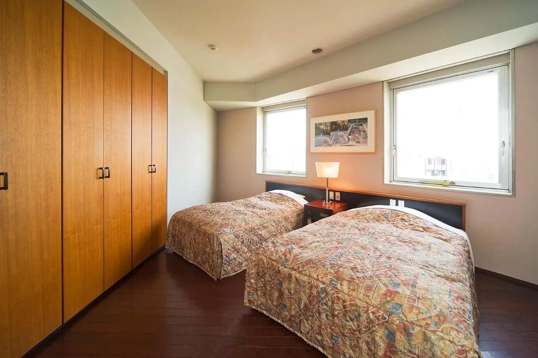 Bed in The Residential Suites Fukuoka